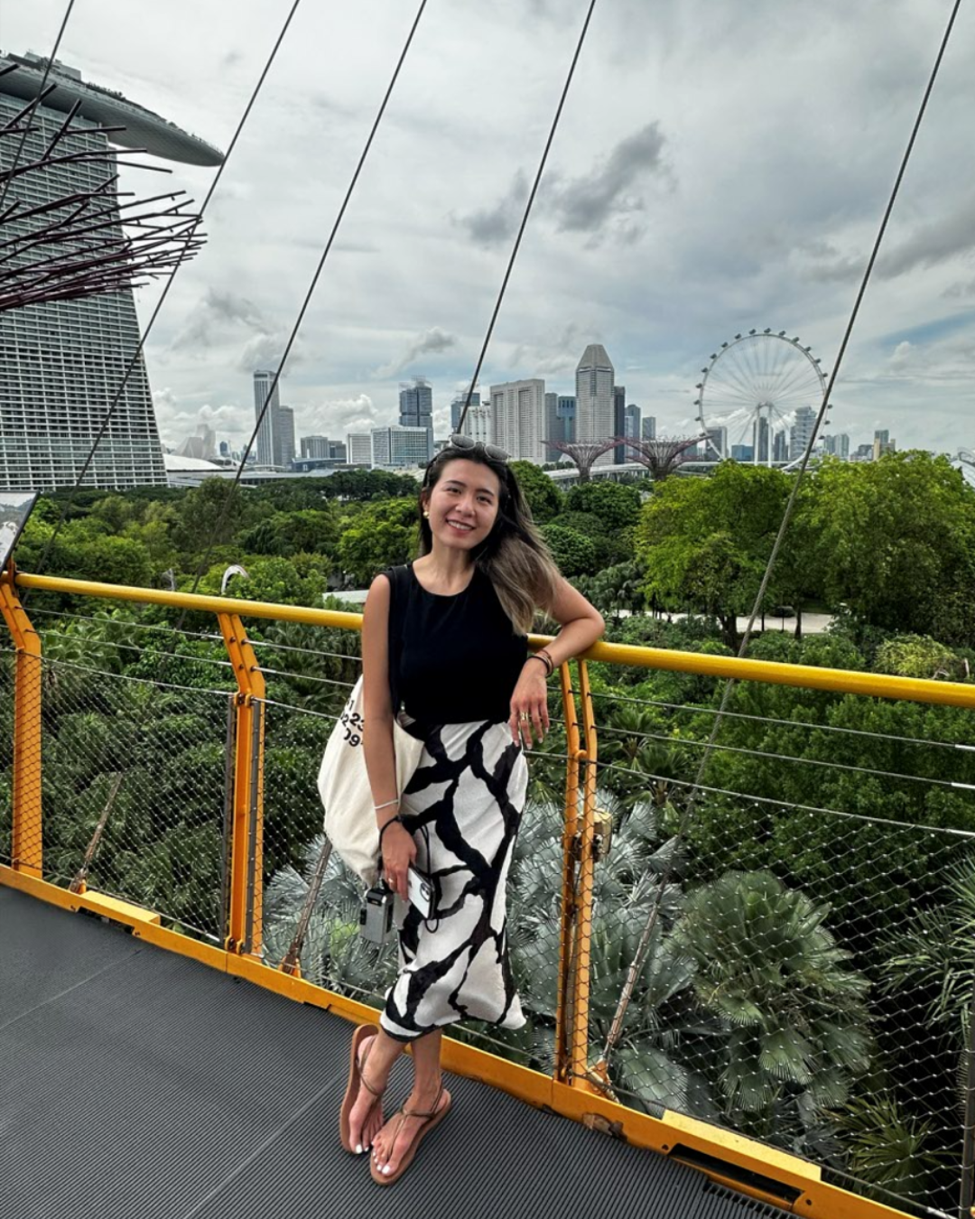 Ashley Chang standing on a bridge connecting the Supertrees.