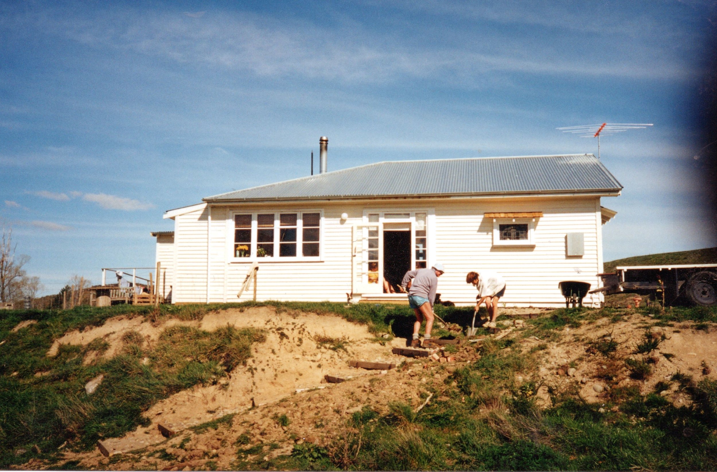 The original house when it was first placed on the section. Hamish's mother and grandfather workign on the landscaping.jpg
