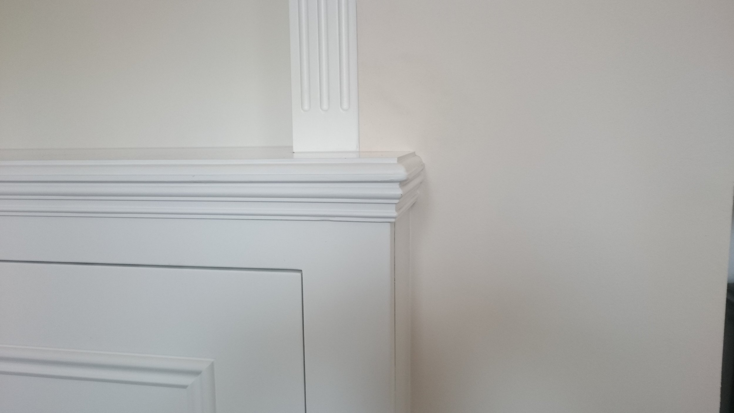 Close-up of white picture frame molding molding decorative trim on wall