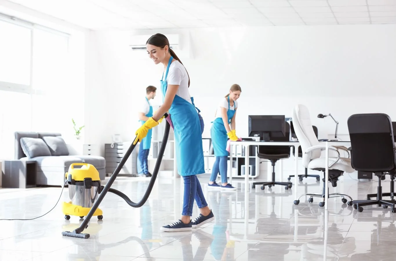 A Beyond Cleaning janitor in Edmond, OK cleaning an office lobby with modern tools, ensuring a spotless, hygienic business environment.