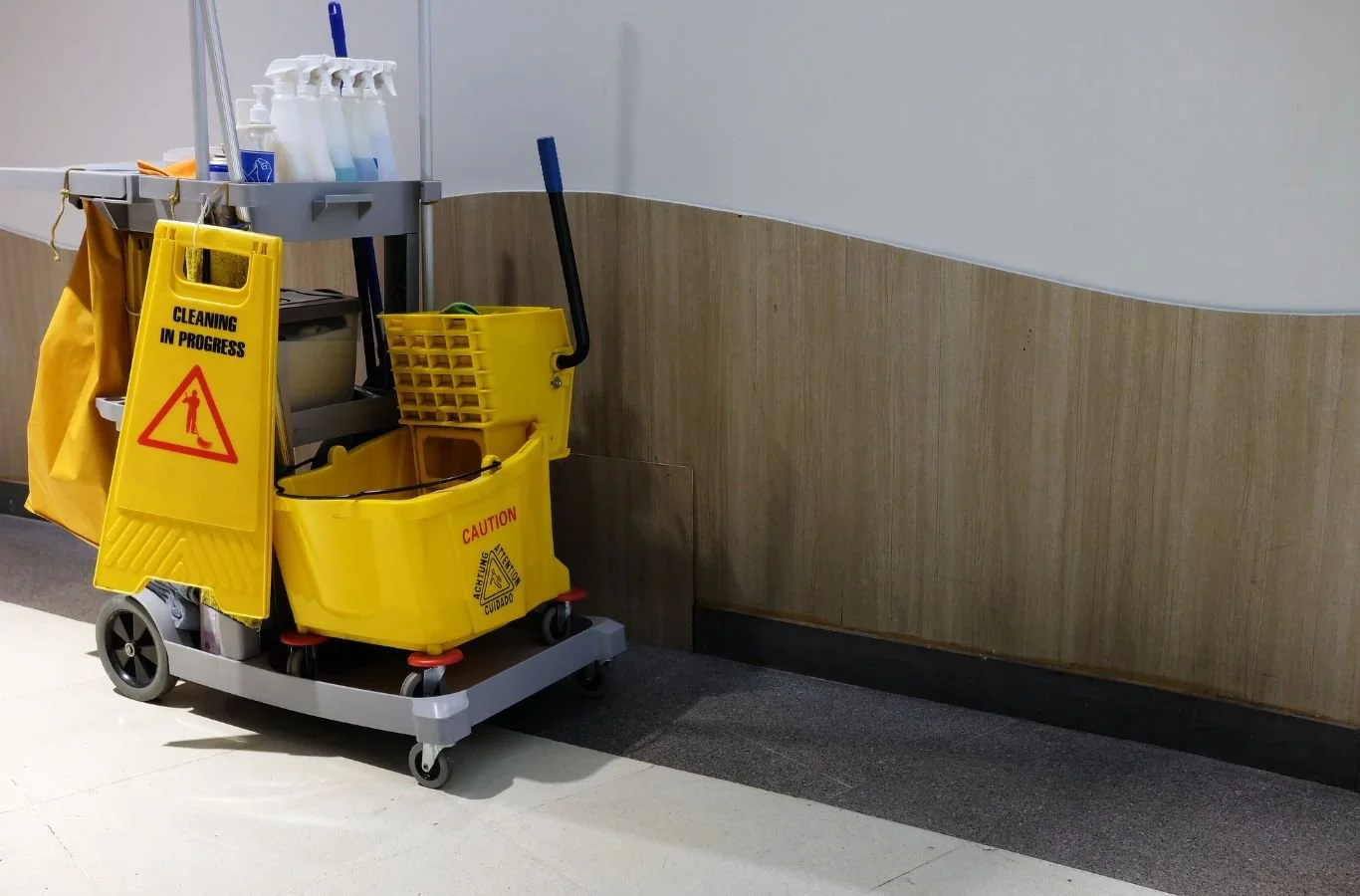 A Beyond Cleaning technician in Oklahoma City, OK cleaning an office floor and work-area, showcasing advantages of hiring a trusted local janitorial provider.