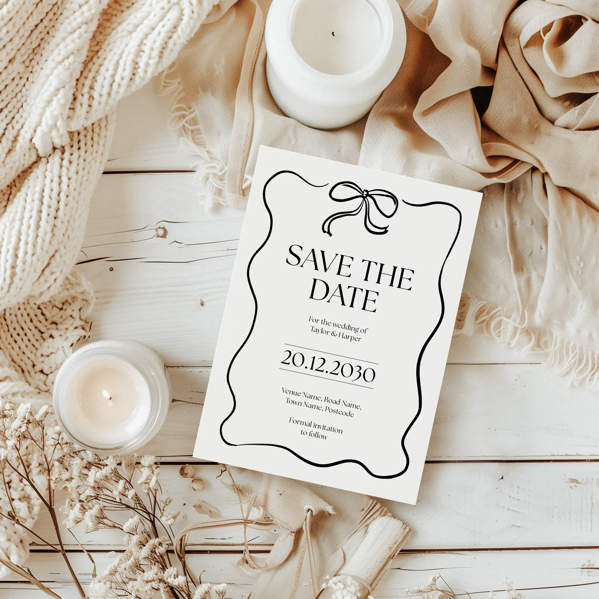 Styled view of Black Tie Save the Date card on a wedding table.