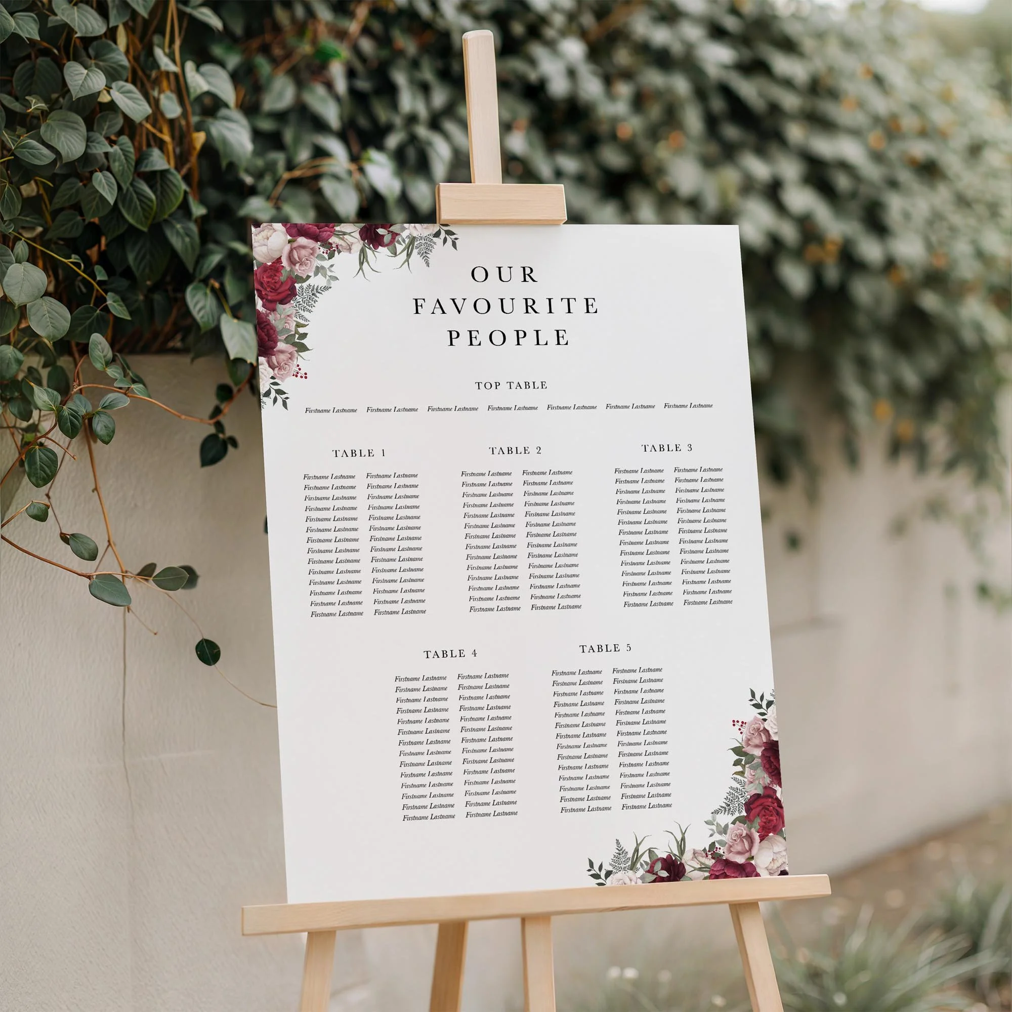 Close-up of the Burgundy and Pink Floral wedding seating plan board displayed outdoors