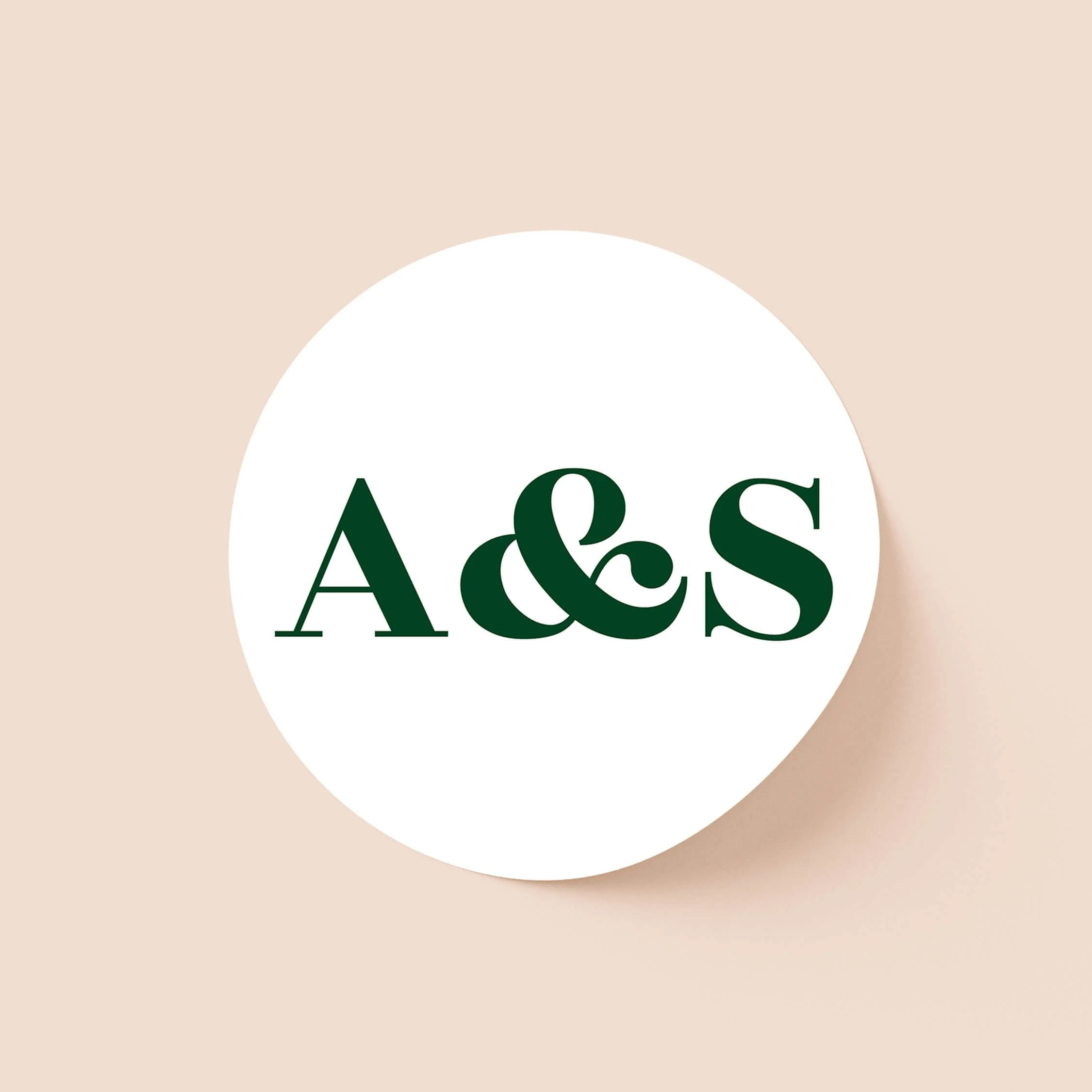 Personalised round wedding stickers with bold green initials in minimalist typography design for modern wedding stationery