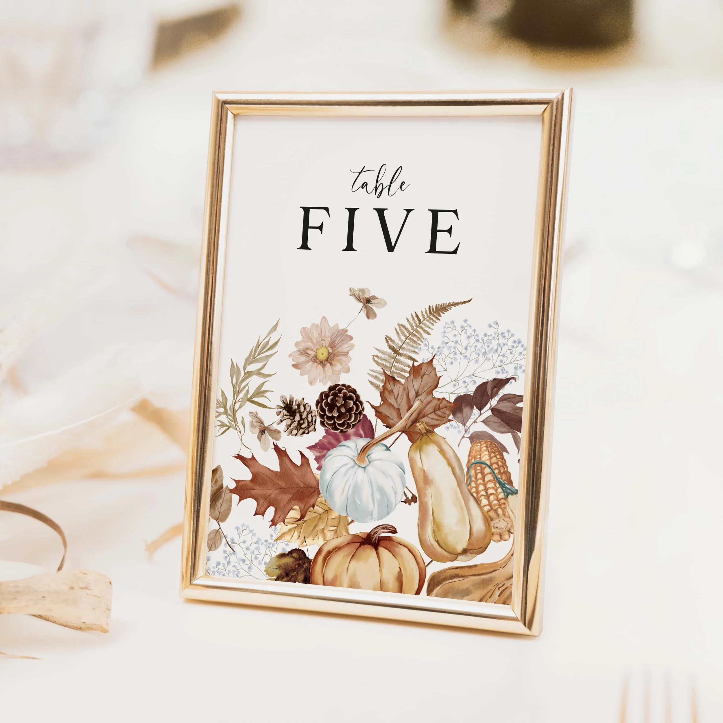 Autumn wedding table number with seasonal botanical illustration featuring pumpkins, autumn leaves and warm burnt orange and terracotta tones printed on luxury off-white textured card