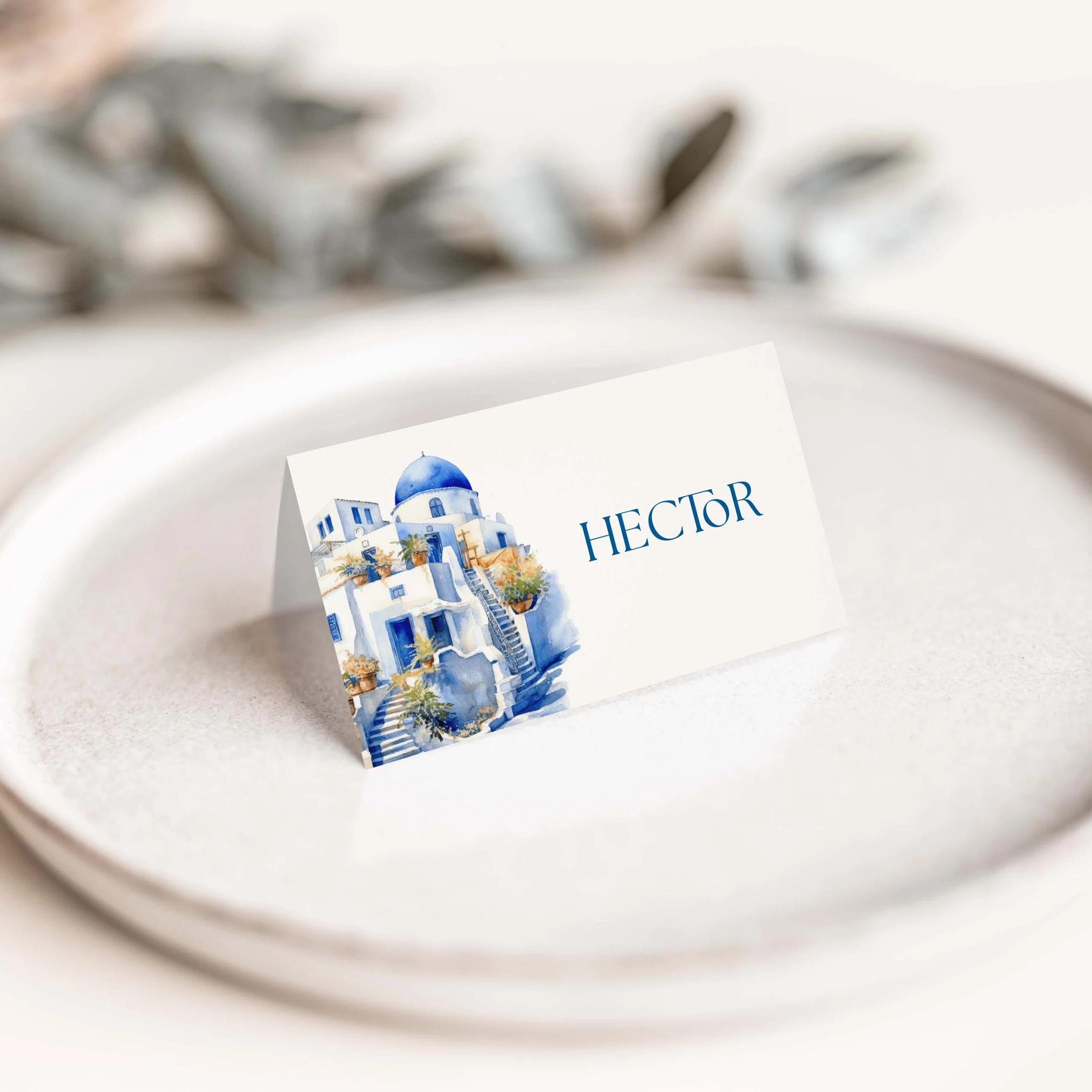 Santorini wedding place card with blue and white coastal illustration