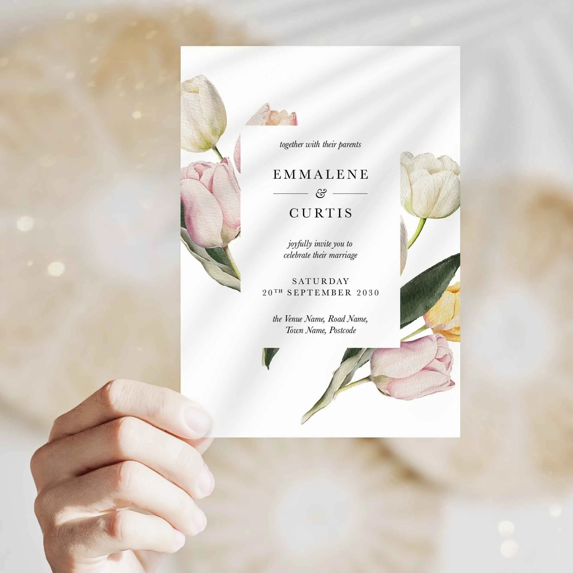Hand holding Pink, White, and Yellow Tulip wedding invitation showing size and printed design details