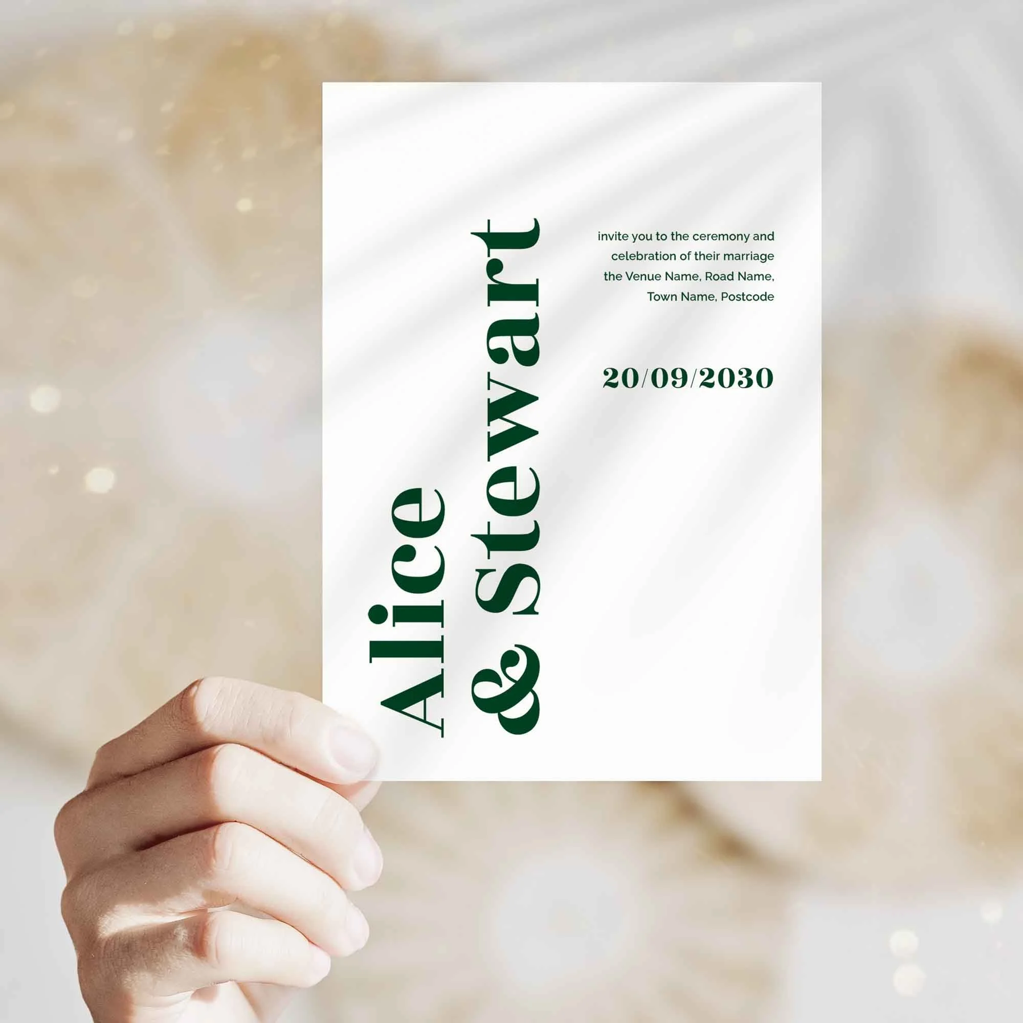 Hand holding Typography wedding invitation showing size and printed design details