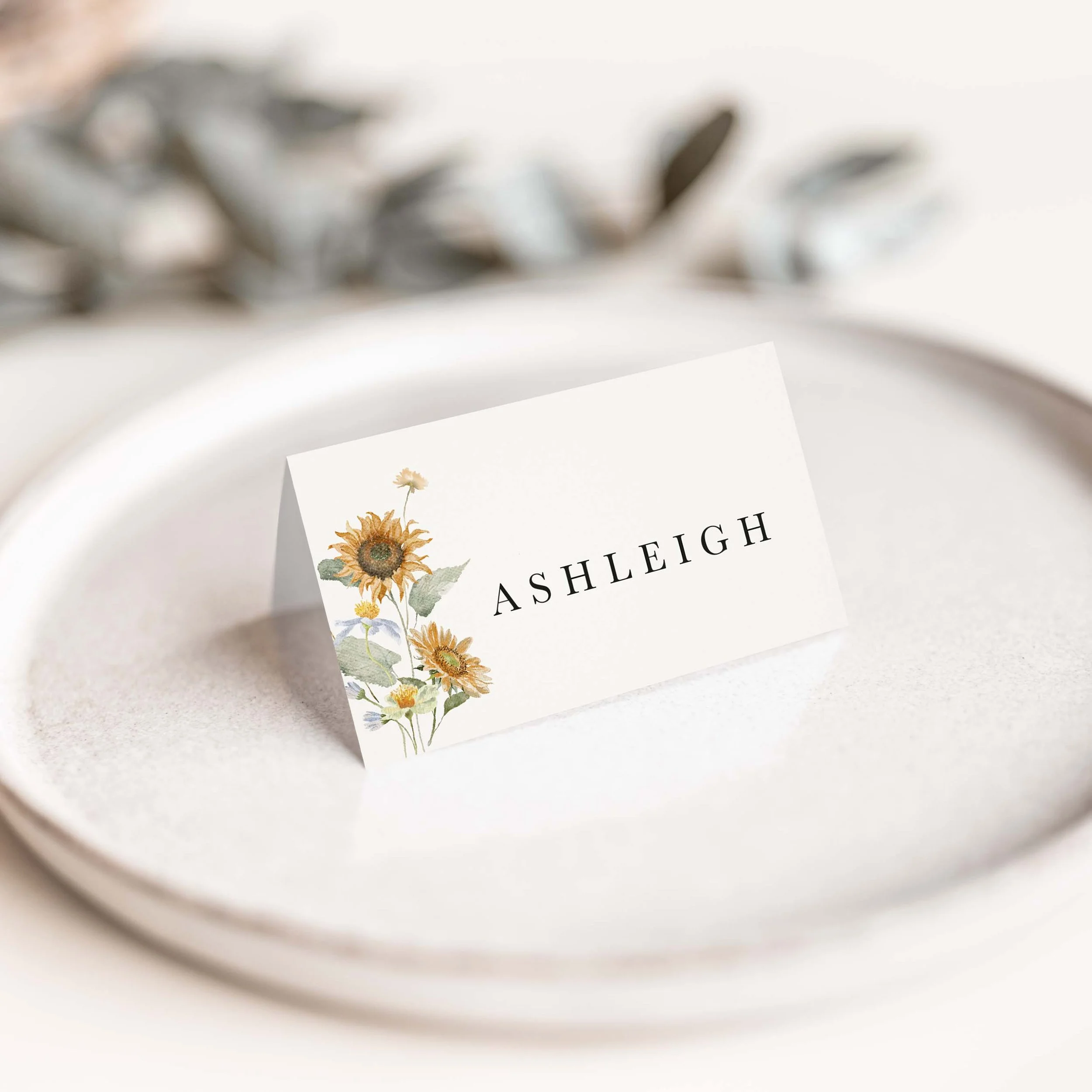 Autumn Sunflower wedding place card with golden sunflower floral illustration and warm autumn foliage on luxury off-white card