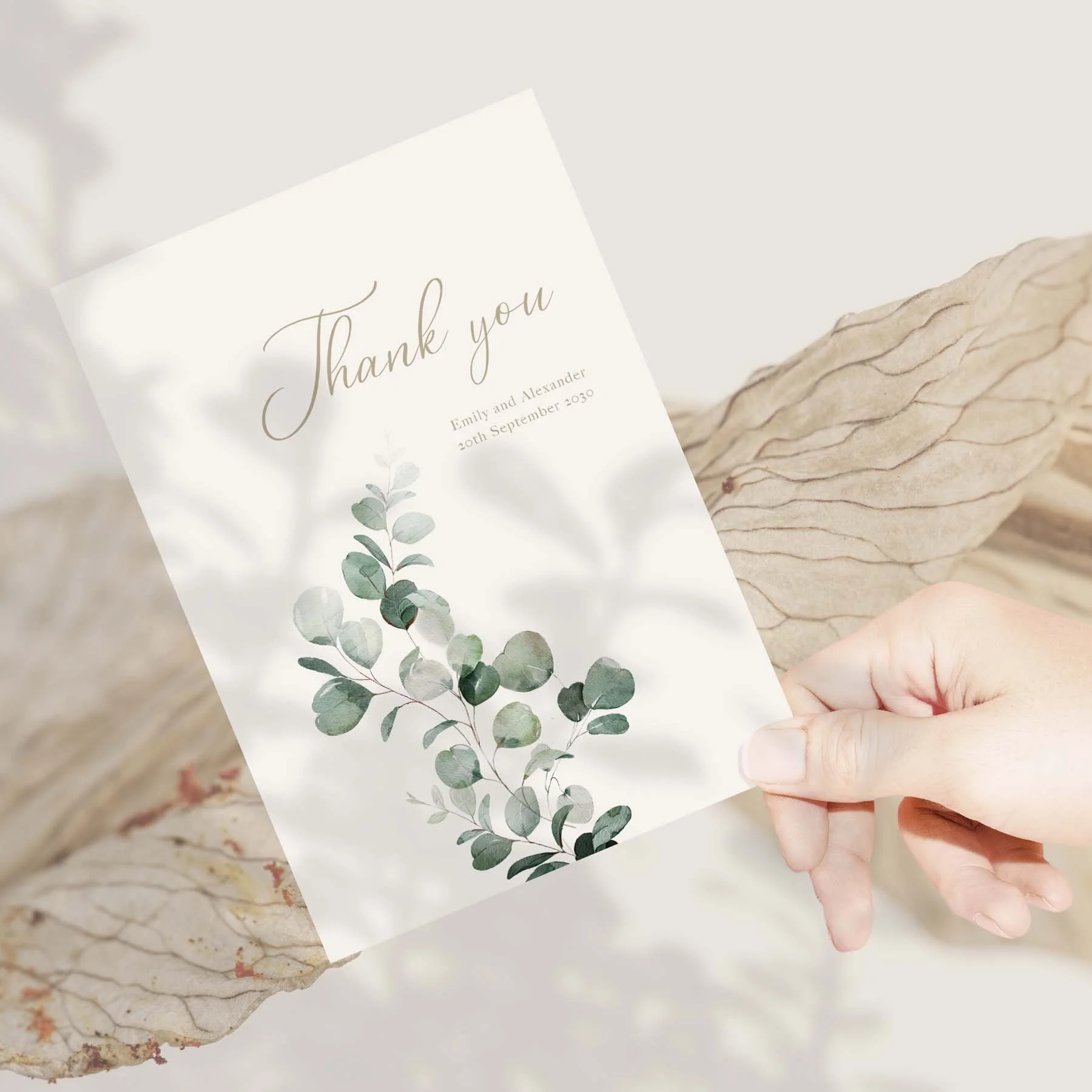 Hand holding an Emerald Leaves wedding thank you card