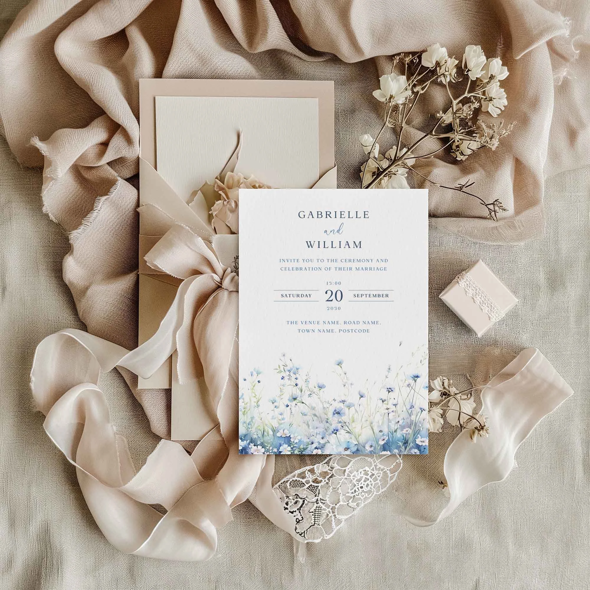 Field Dusty Blue wedding invitation styled in a flat lay environment with wedding props
