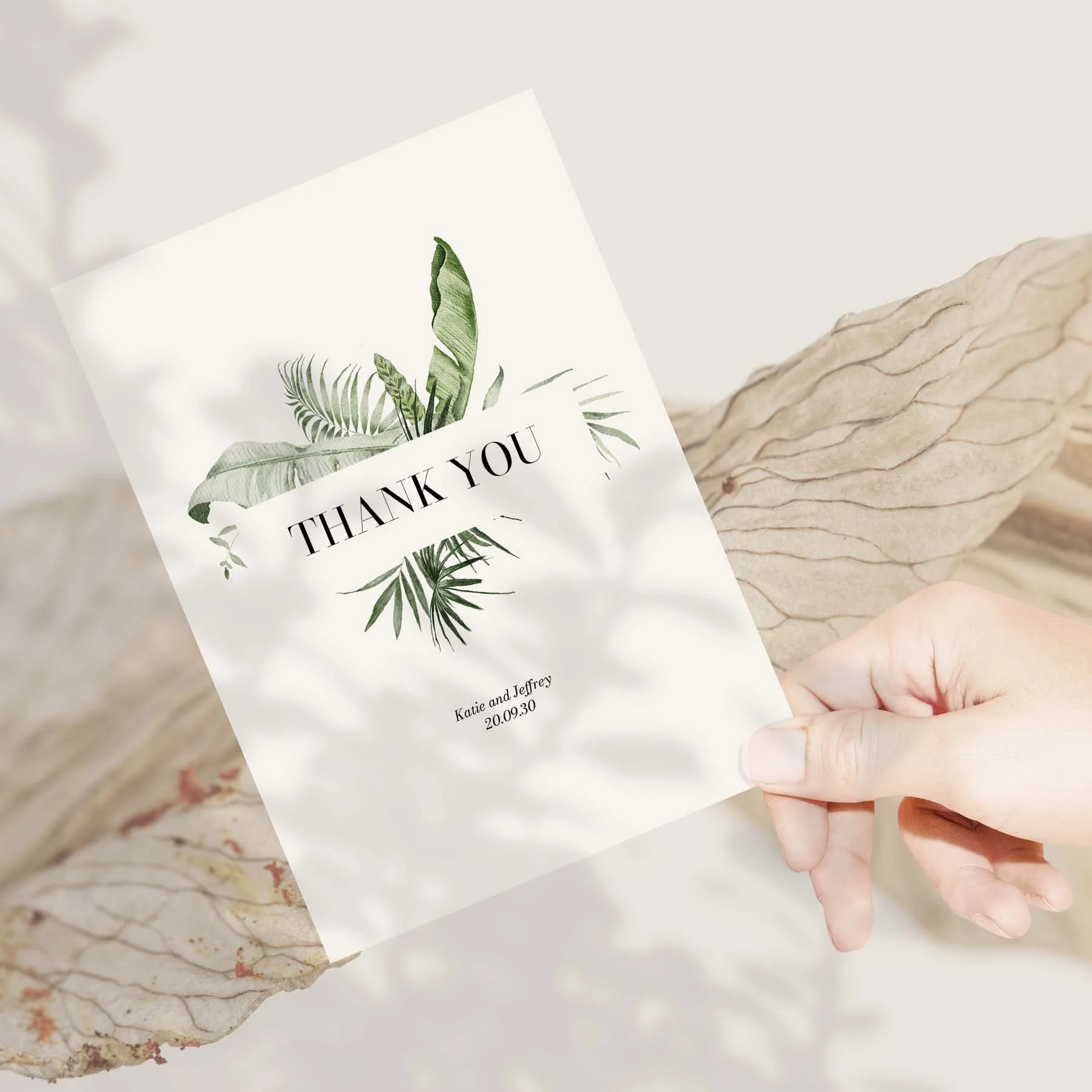 Hand holding a Modern Tropical wedding thank you card