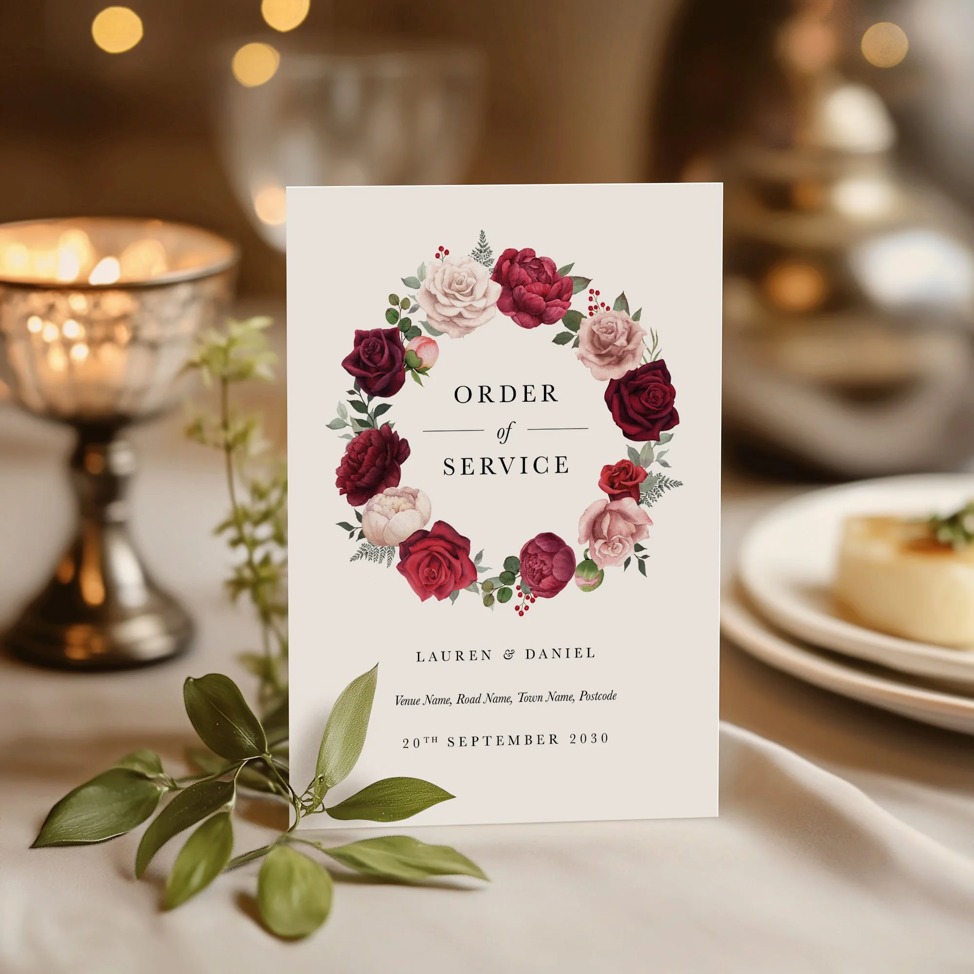 Burgundy and pink rose wedding order of service on a wedding day displayed
