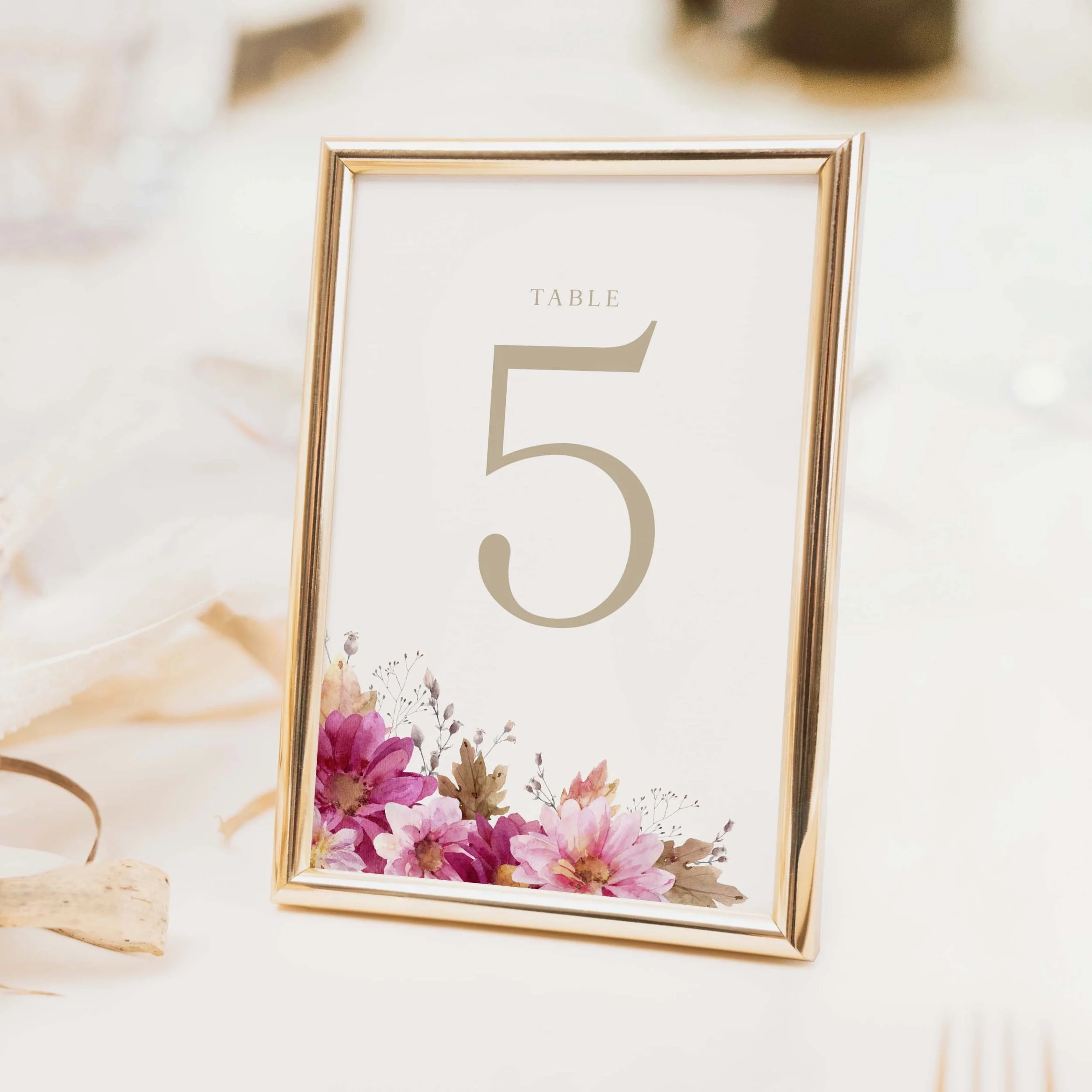 Chrysanthemum wedding table number with richly detailed pink and burgundy chrysanthemum floral illustration and elegant serif typography printed on luxury off-white textured card