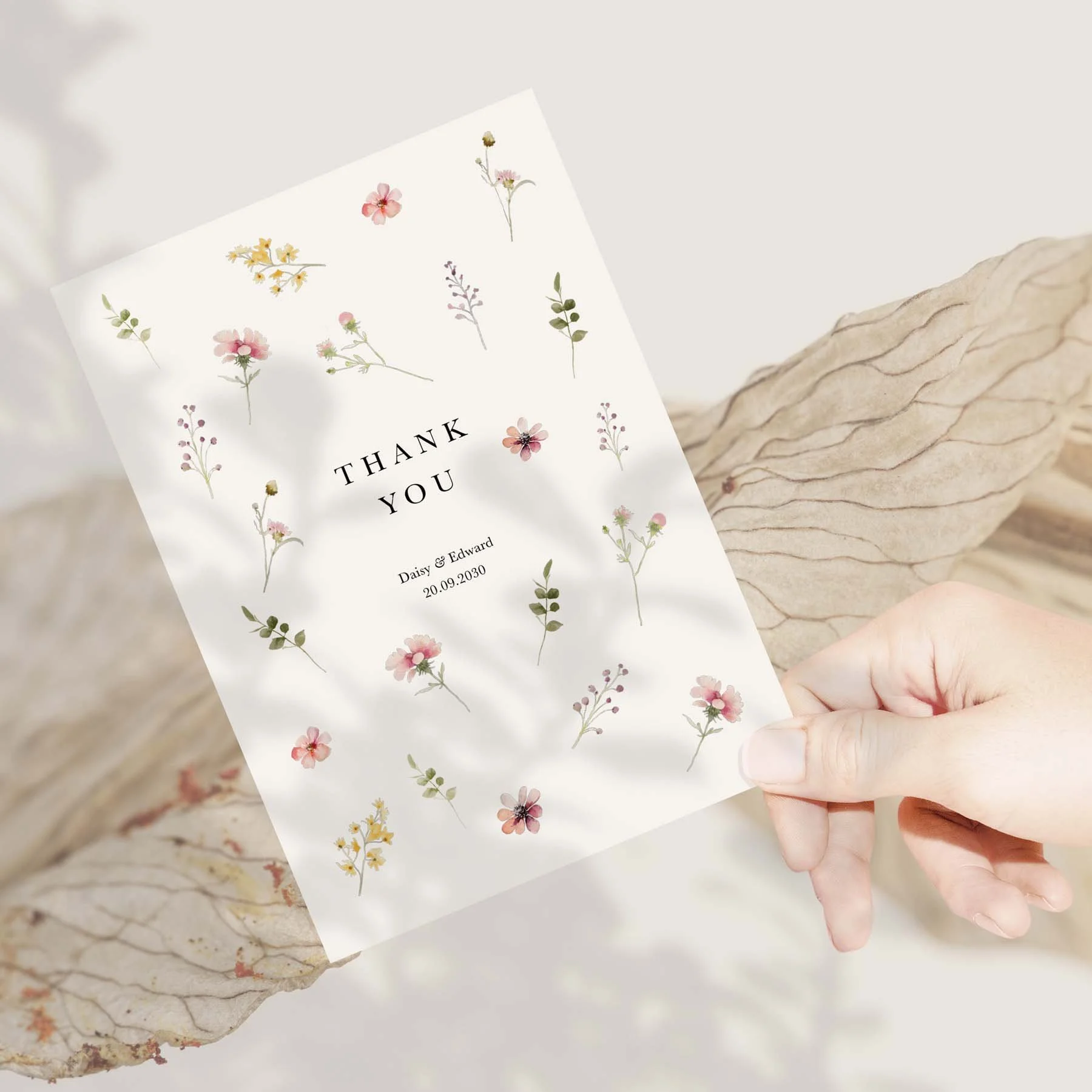 Hand holding a Scattered Flowers wedding thank you card