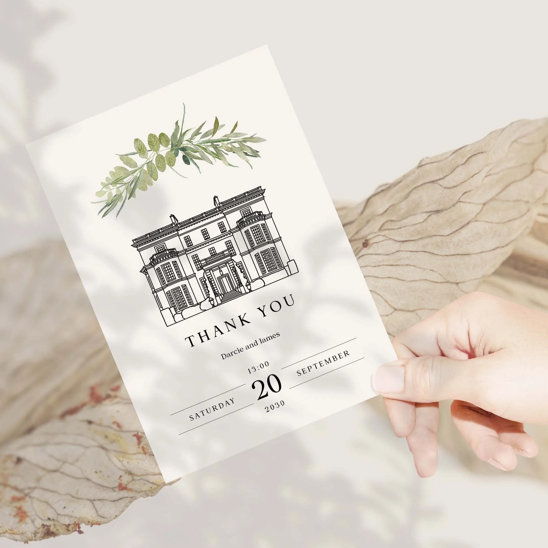 Hand holding a Venue Sketch with Greenery wedding thank you card