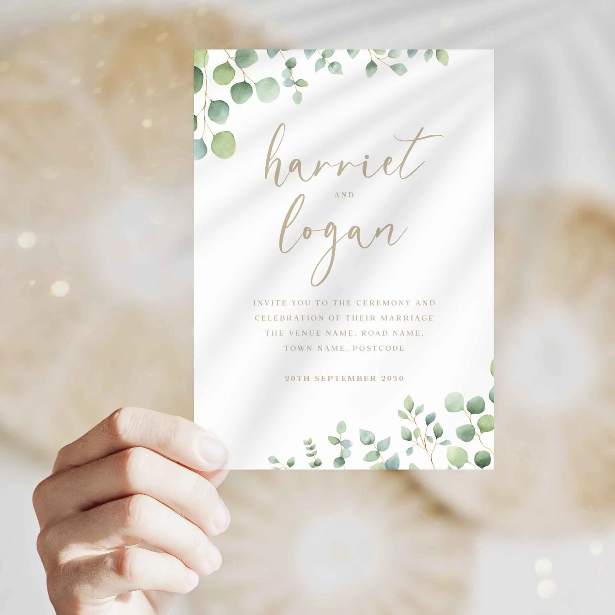 Hand holding Eucalyptus Calligraphy wedding invitation showing size and printed design details
