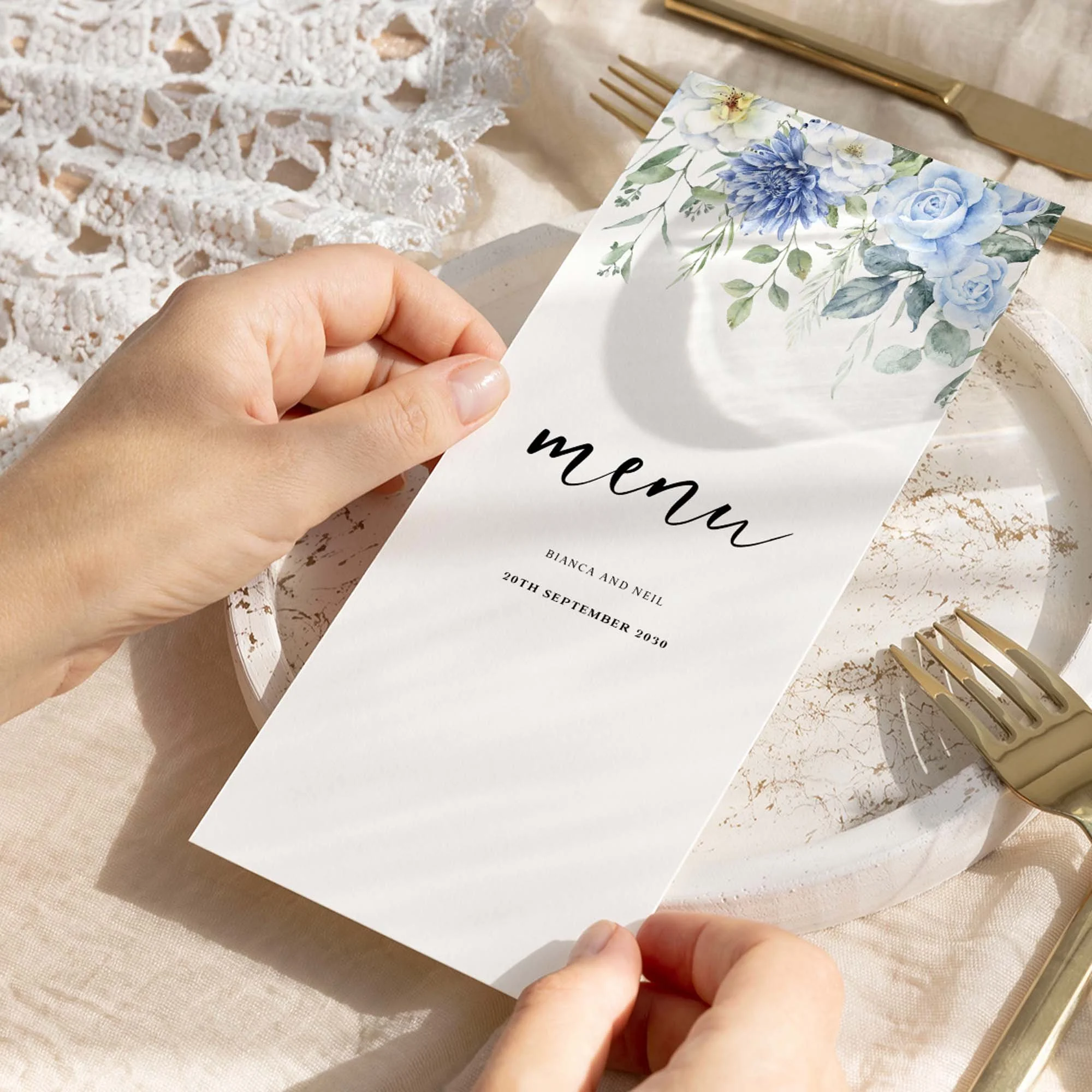 Hand holding Blue Floral wedding menu card showing size and printed design details
