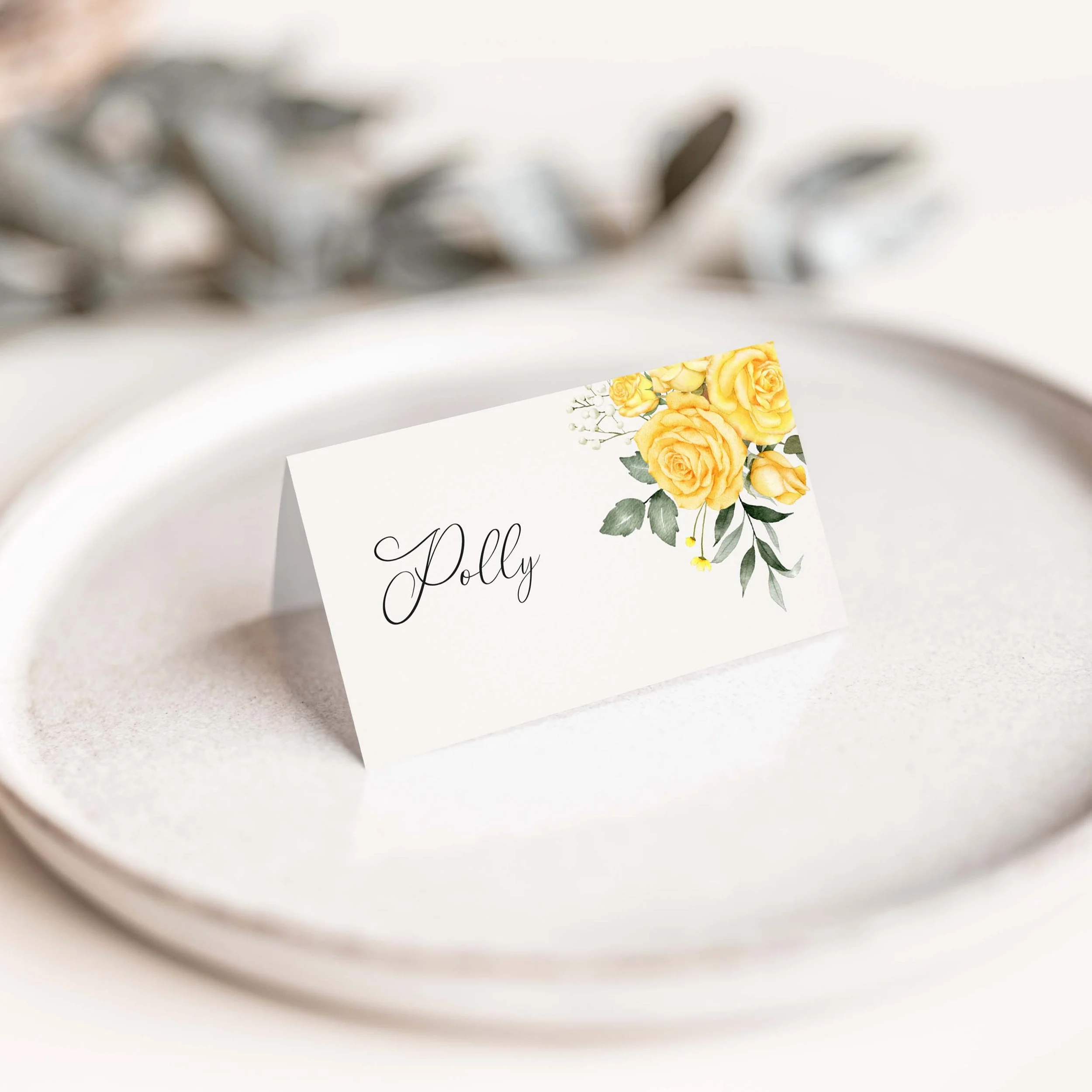Summer Rose wedding place card with soft yellow rose botanical illustration and flowing calligraphy script guest name on luxury off-white card