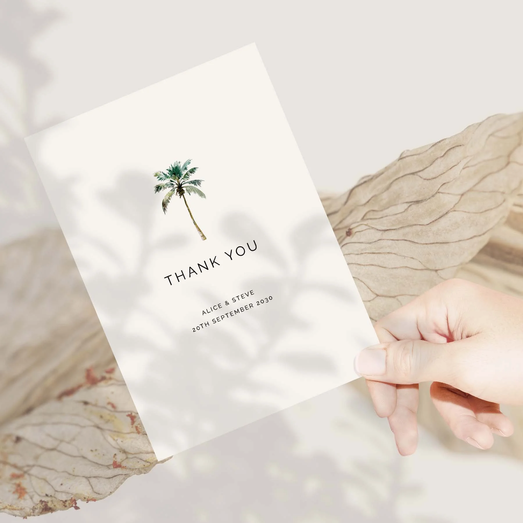 Hand holding a Palm Tree wedding thank you card