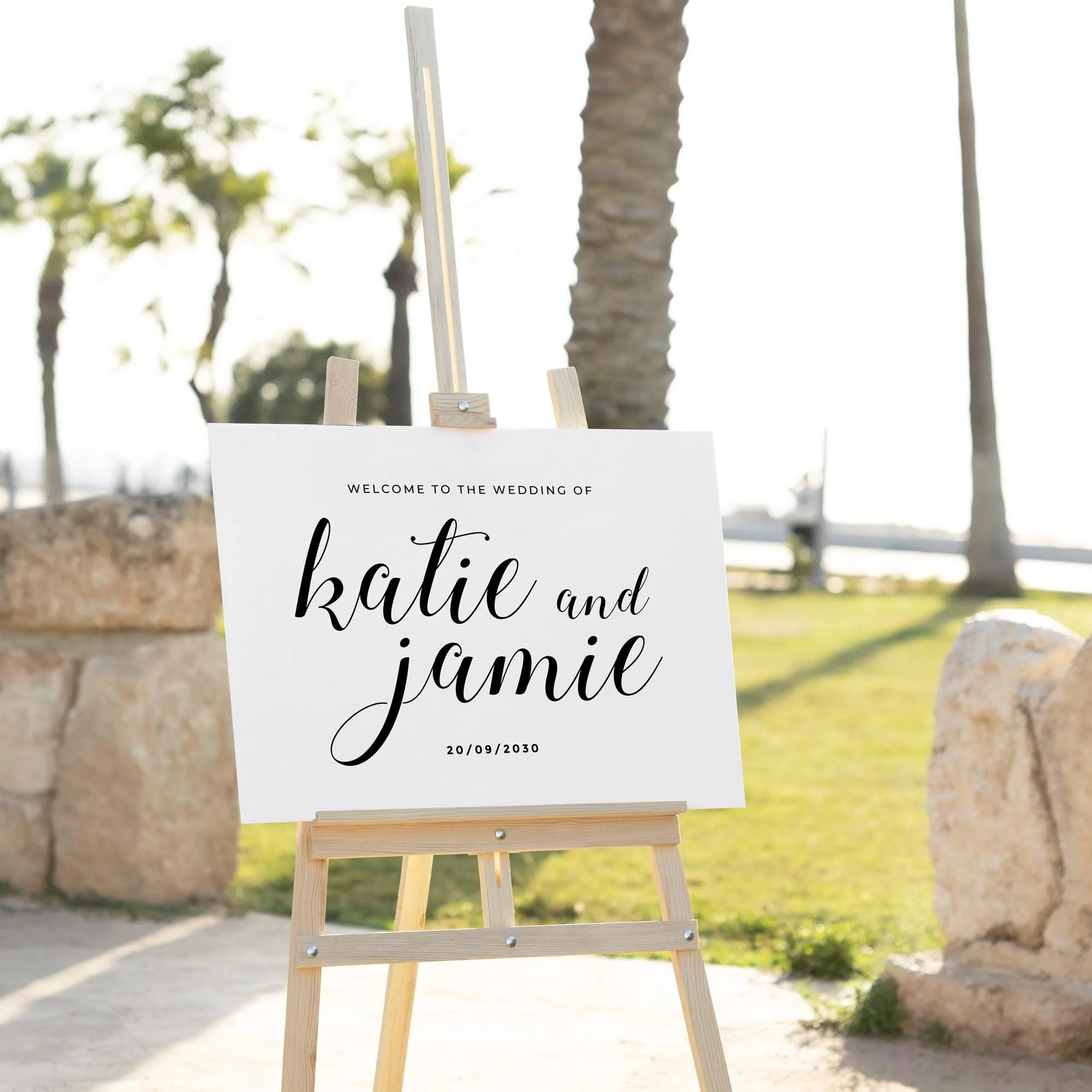 Calligraphy Style wedding welcome sign displayed outdoors at a wedding venue on an easel