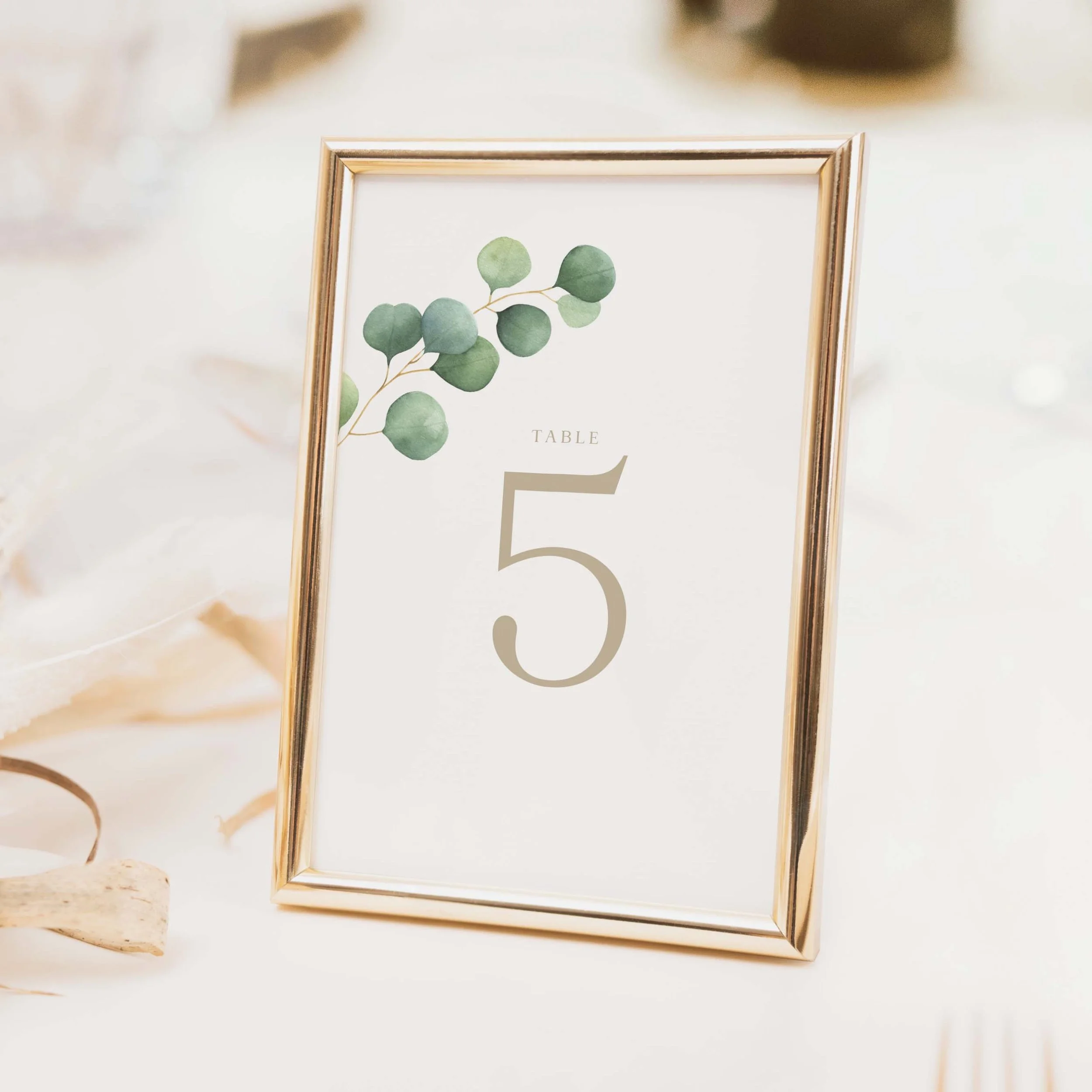 Eucalyptus Foliage wedding table number with botanical eucalyptus border top and clean central numeral on luxury off-white card