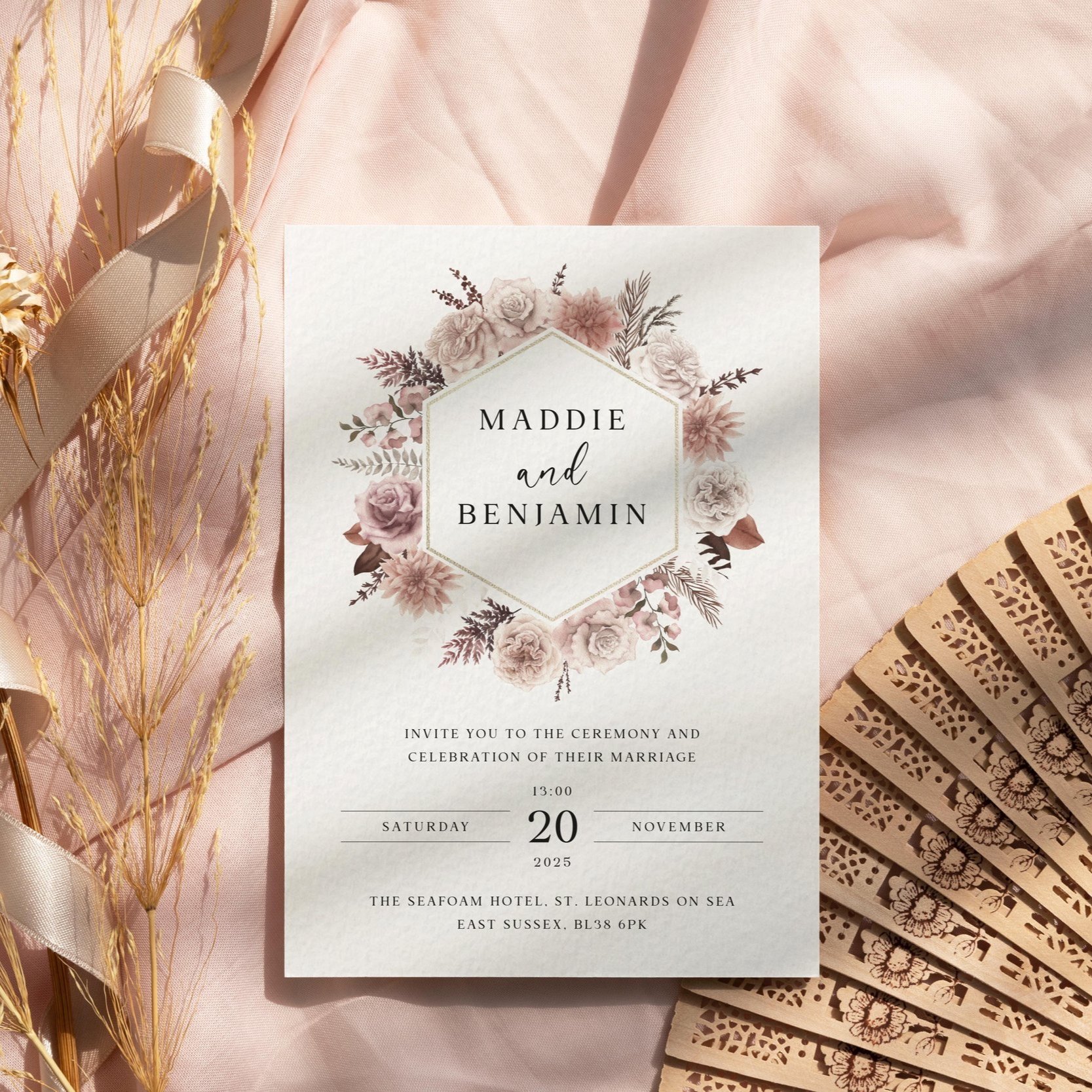 Blush Boho wedding invitation featuring a dusty pink floral wreath surrounding the couple’s names, in a soft romantic boho style.
