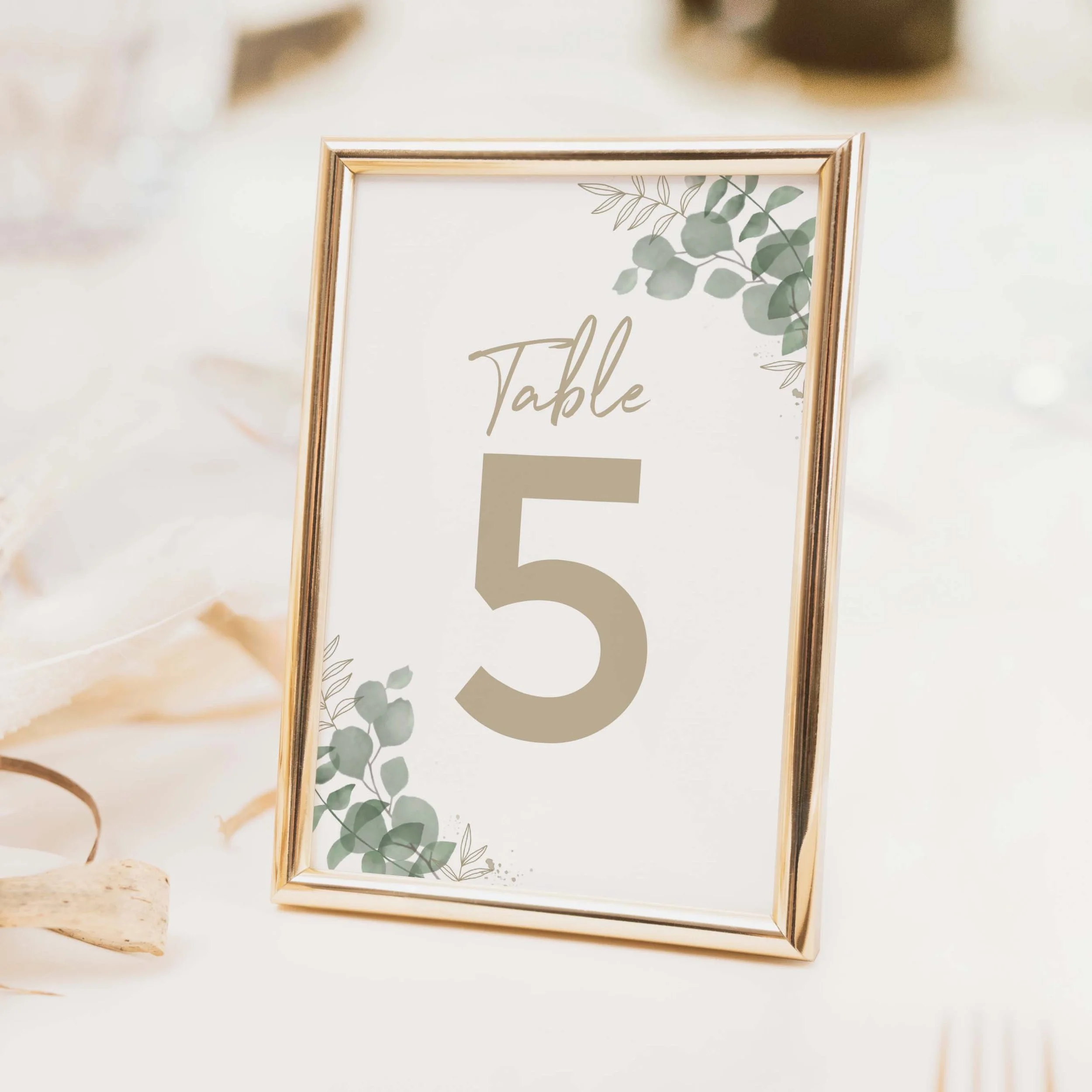 Eucalyptus wedding table number with botanical eucalyptus spray illustration and large clean numeral on luxury off-white card