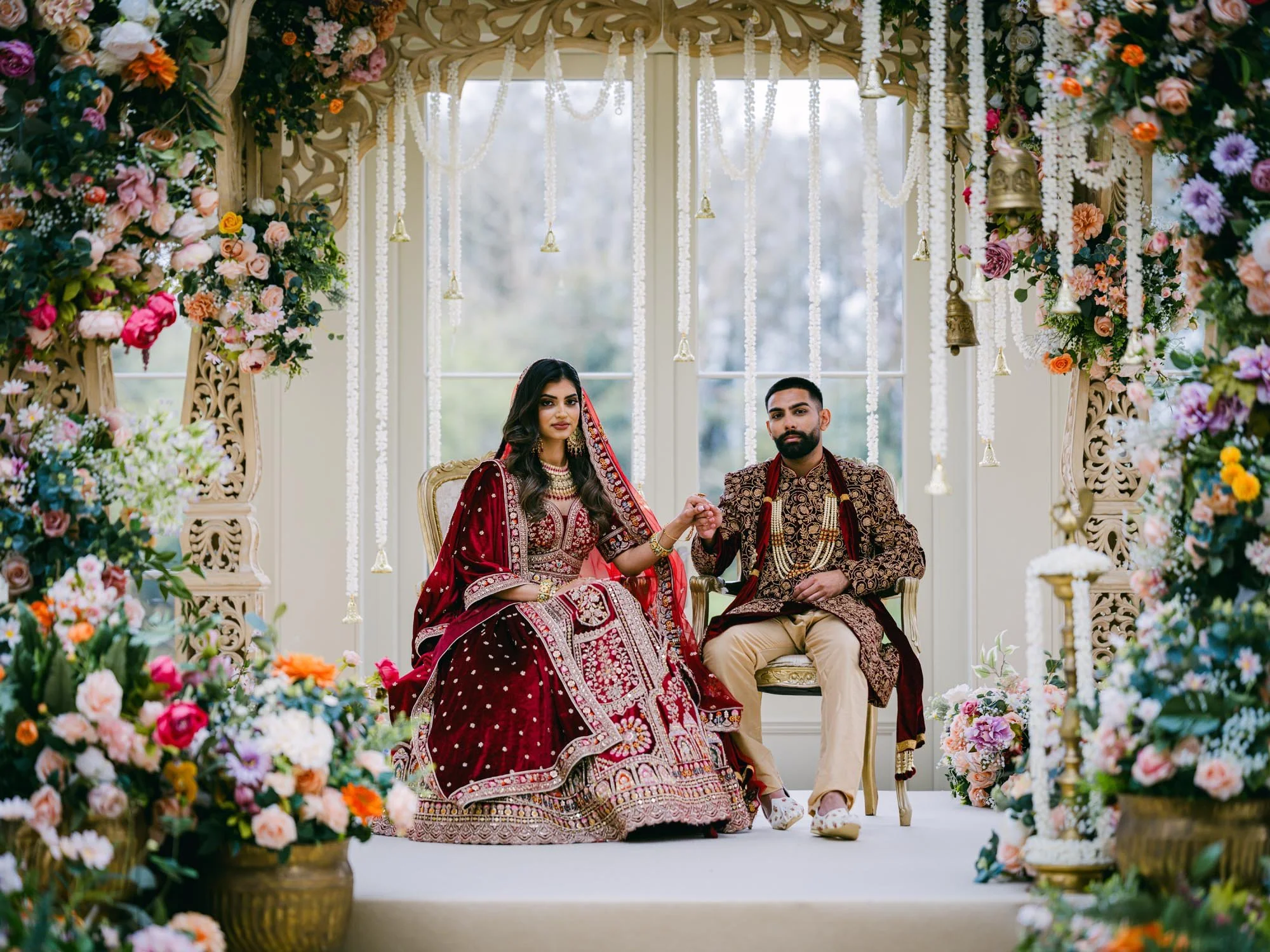 Bride and groom sitting at Indian themed wedding