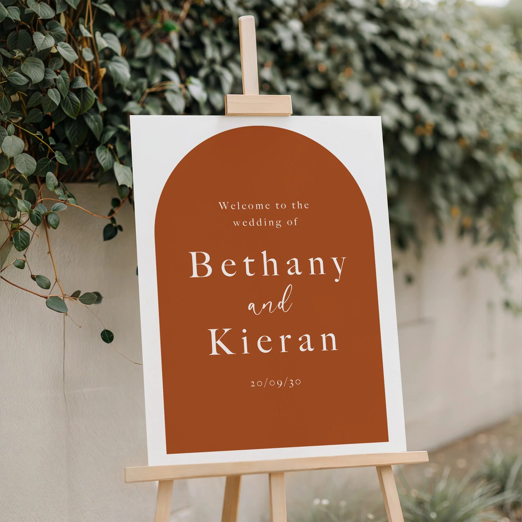 Close-up of the Arch wedding welcome board displayed outdoors