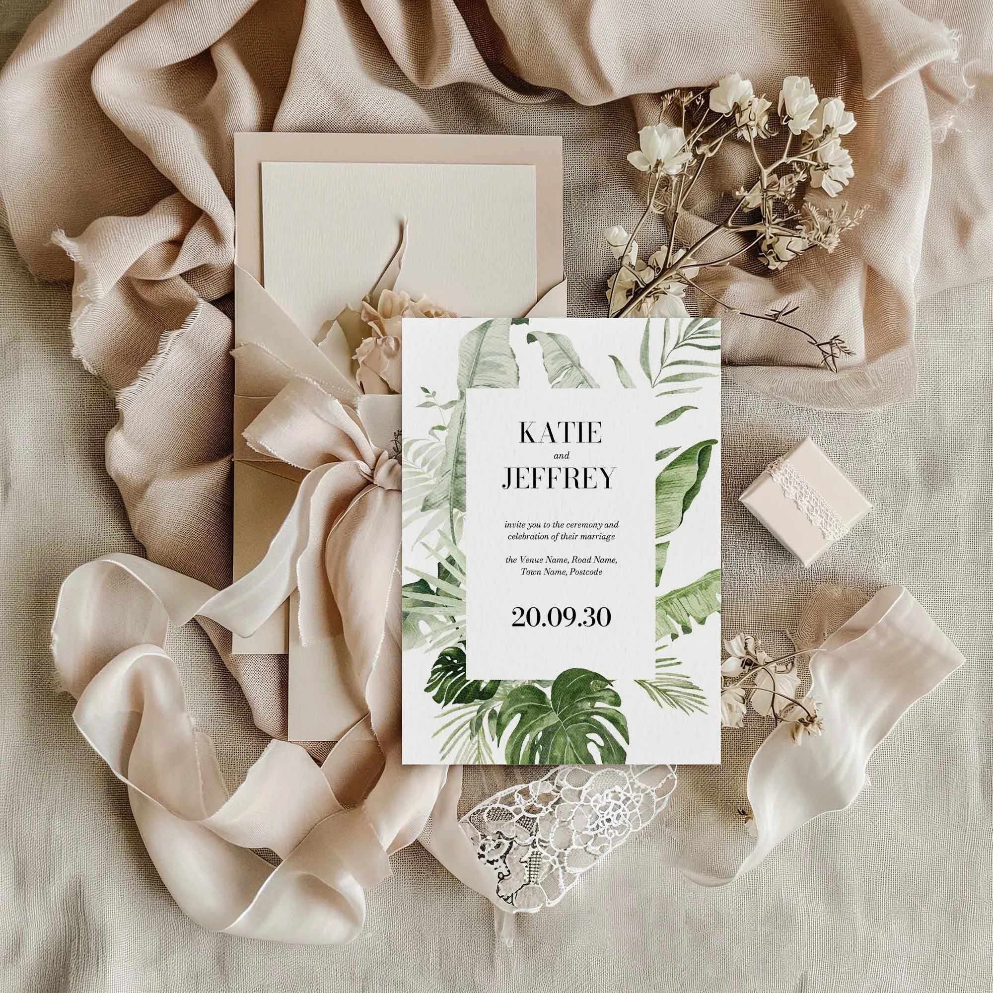 Modern Tropical wedding invitation styled in a flat lay environment with wedding props