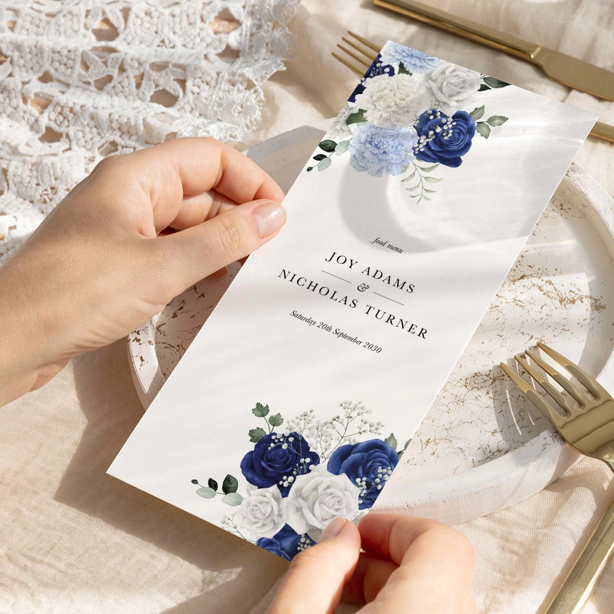 Hand holding Blue and White Rose wedding menu card showing size and printed design details