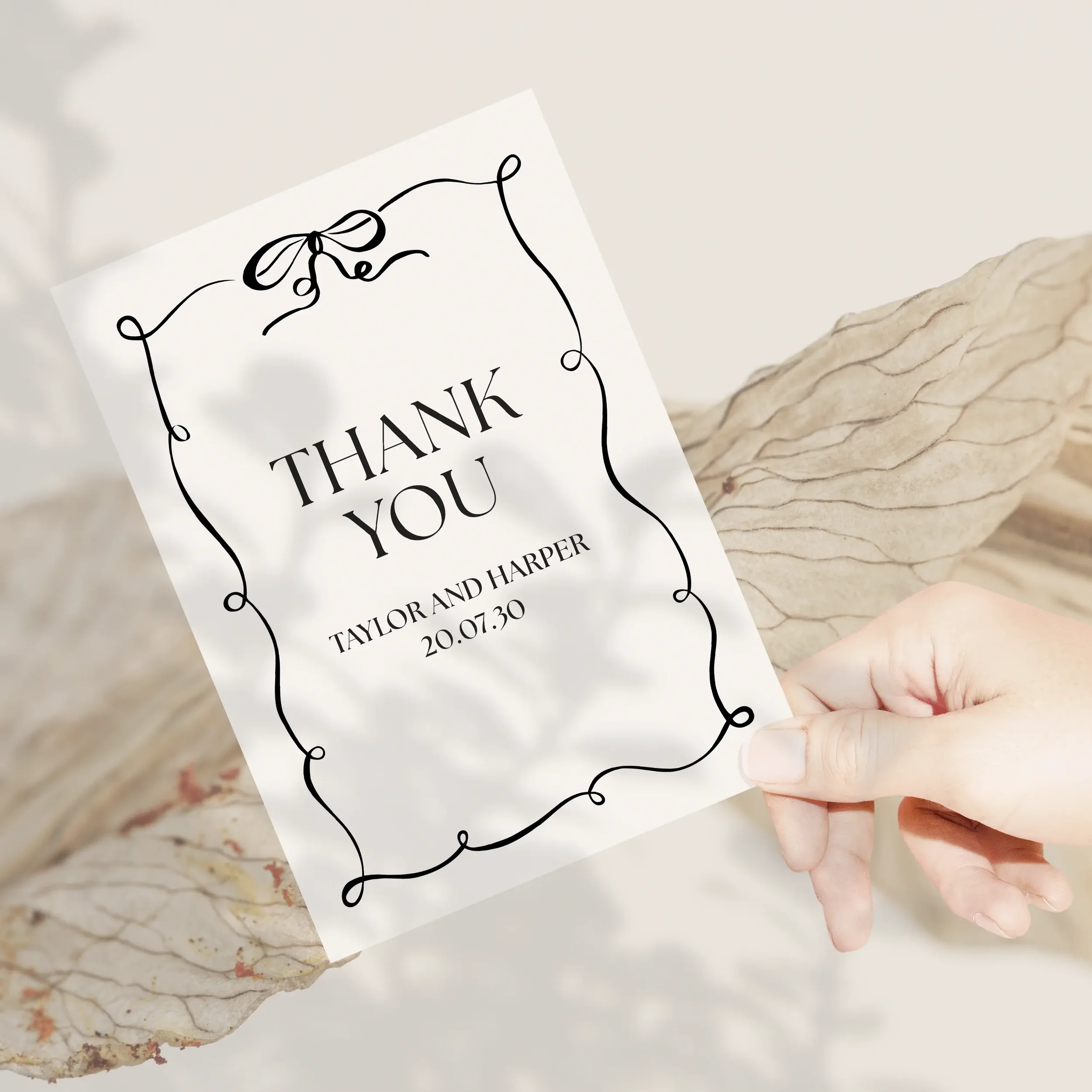 Person holding Black Tie Wedding Thank You Card with elegant black bow and bold border.