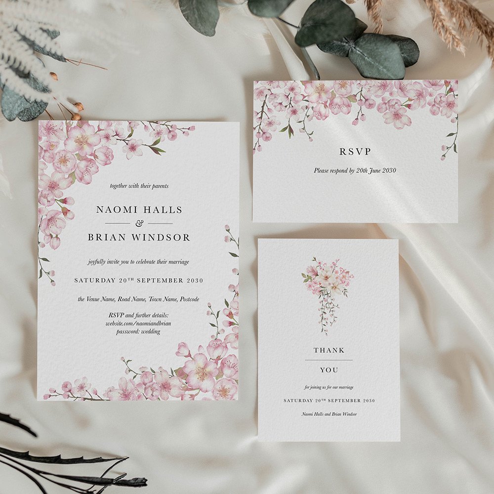 Cherry blossom wedding invitation card with soft pink florals elegantly framing the invite, perfect for a romantic spring wedding.