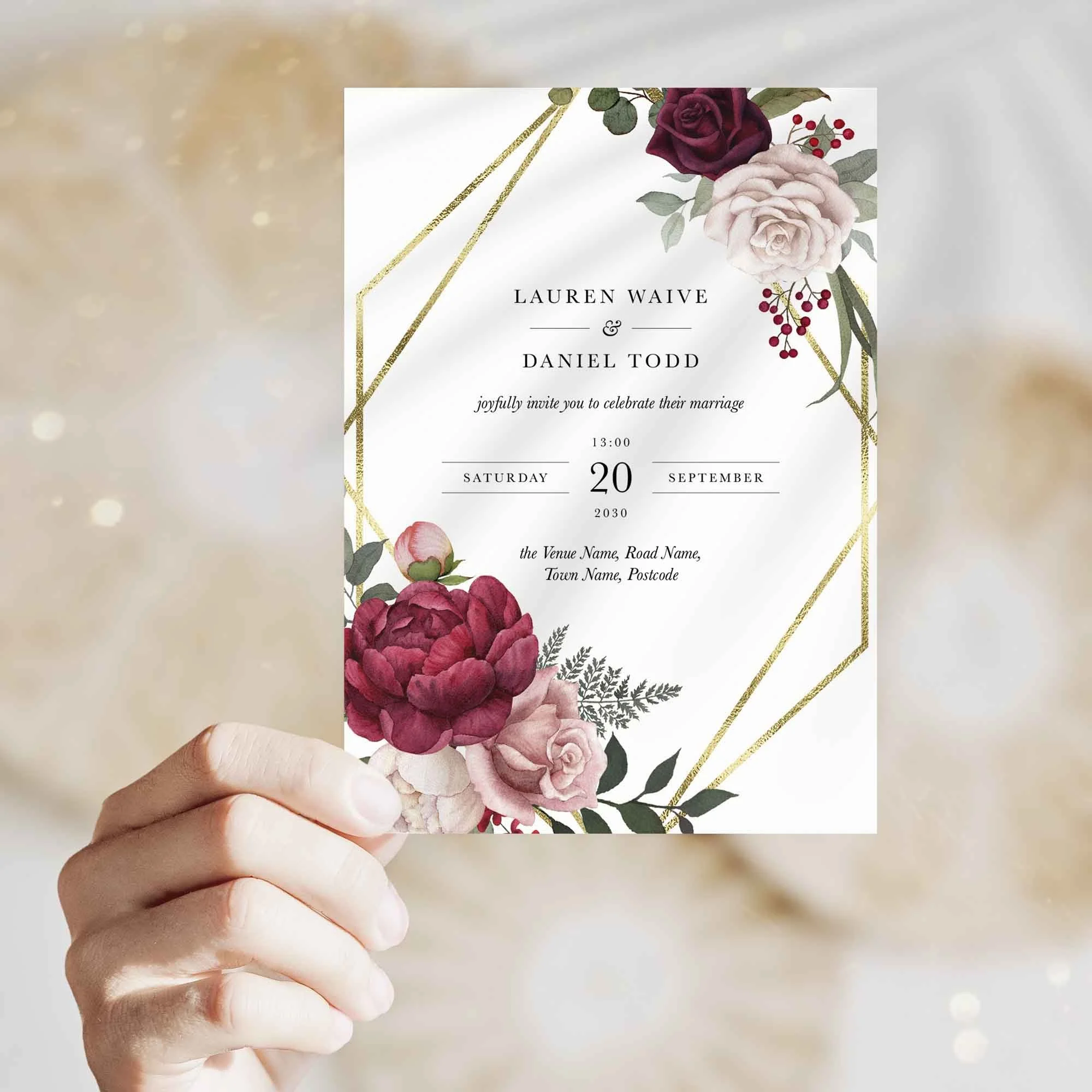 Hand holding Pink and Burgundy Floral with Gold Frame wedding invitation showing size and printed design details