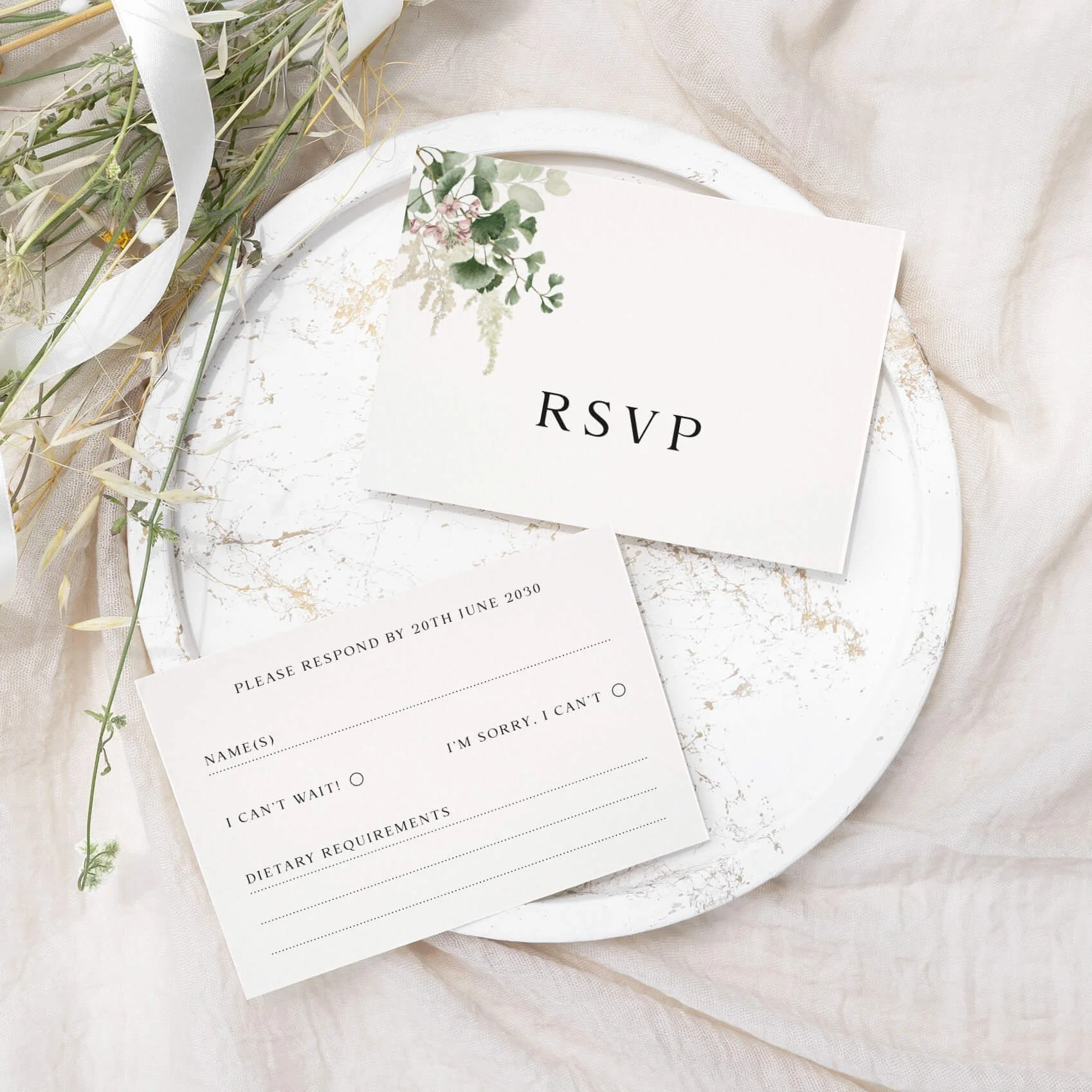 Forest wedding RSVP card with watercolour green foliage and botanical illustration on luxury off-white card
