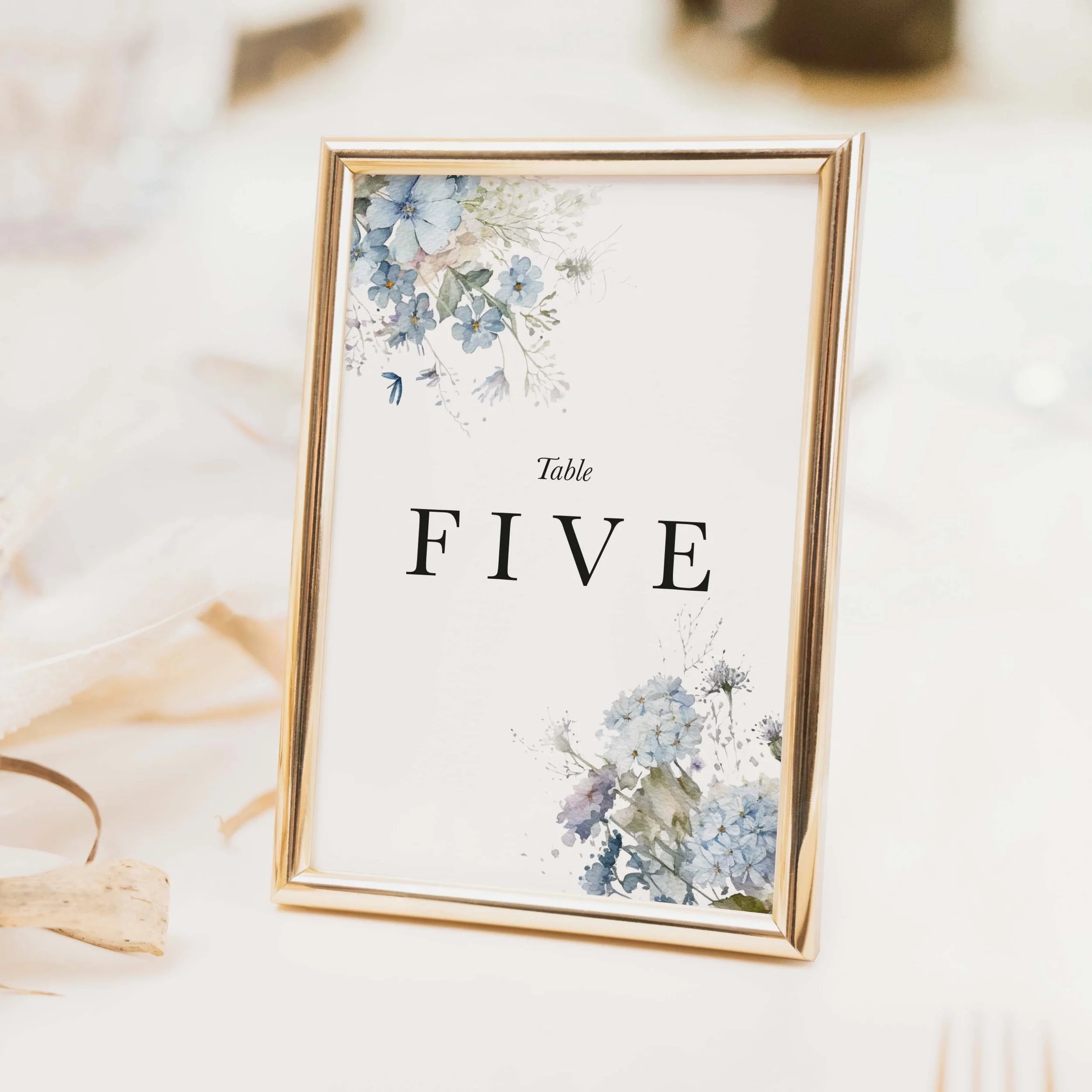 Dusty Blue wedding table number with blue watercolour hydrangea floral illustration and elegant typography on luxury off-white card
