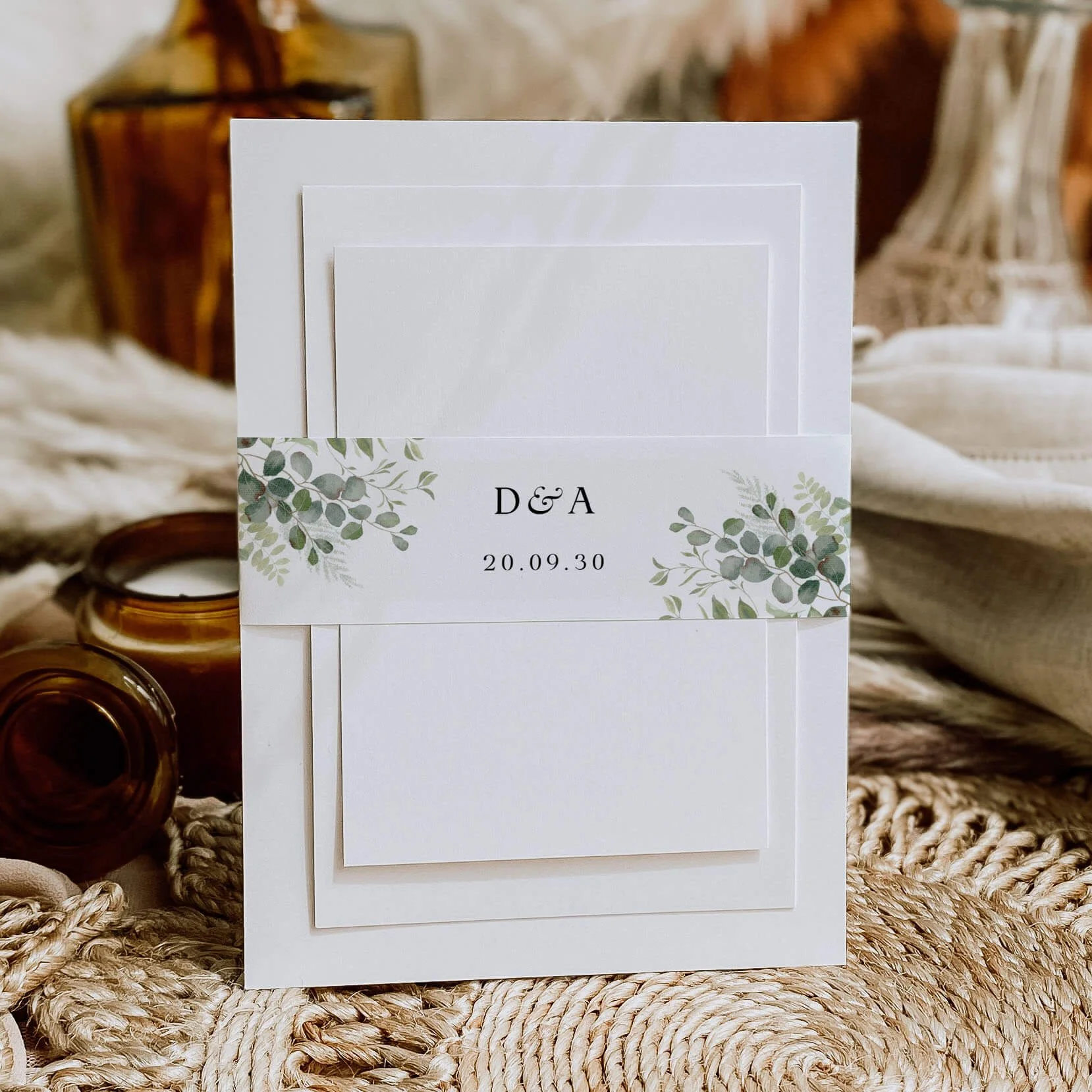 Greenery personalised wedding belly bands with mixed eucalyptus and green botanical watercolour illustration wrapped around wedding invitations