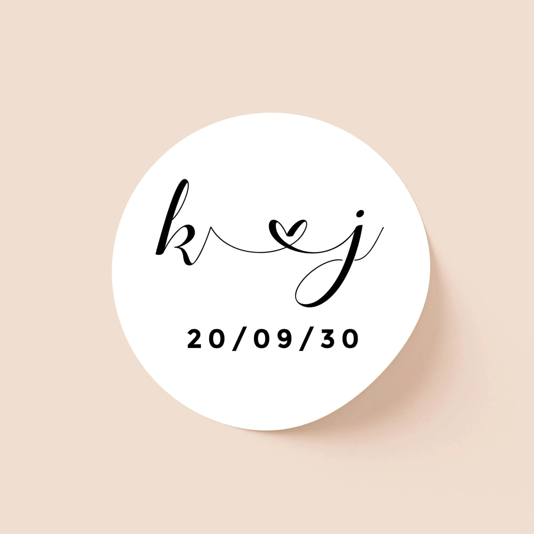 Calligraphy wedding sticker with handwritten initials and heart detail on round personalised seal