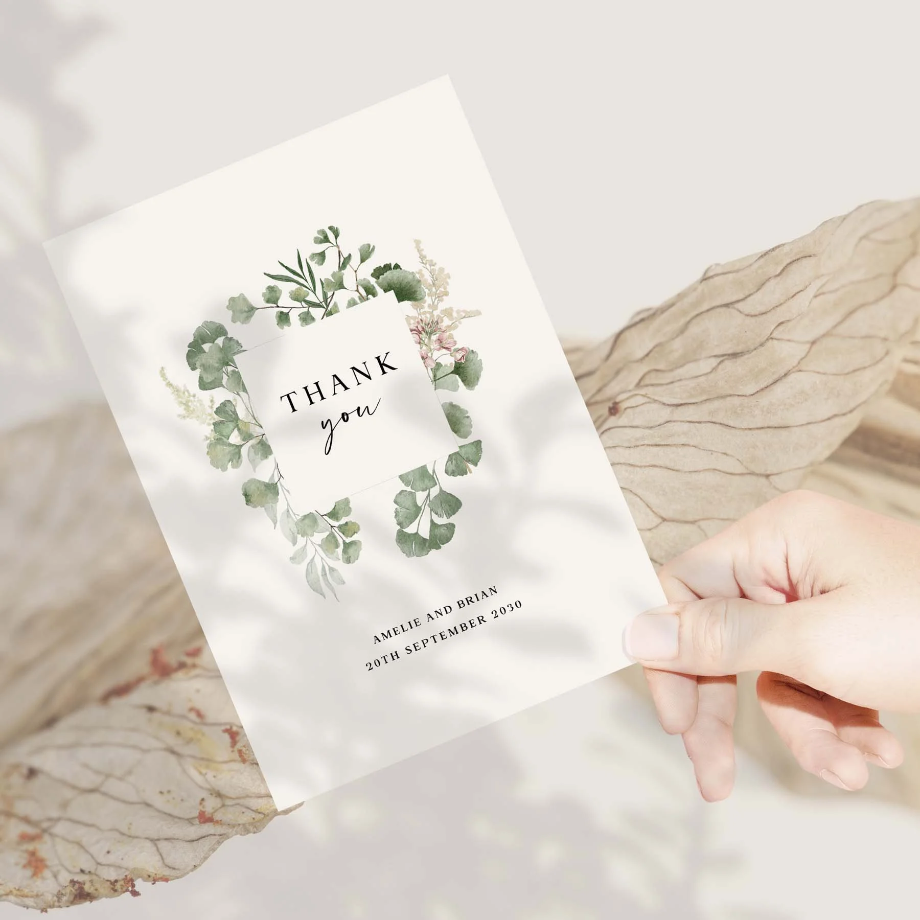 Hand holding a Forest wedding thank you card