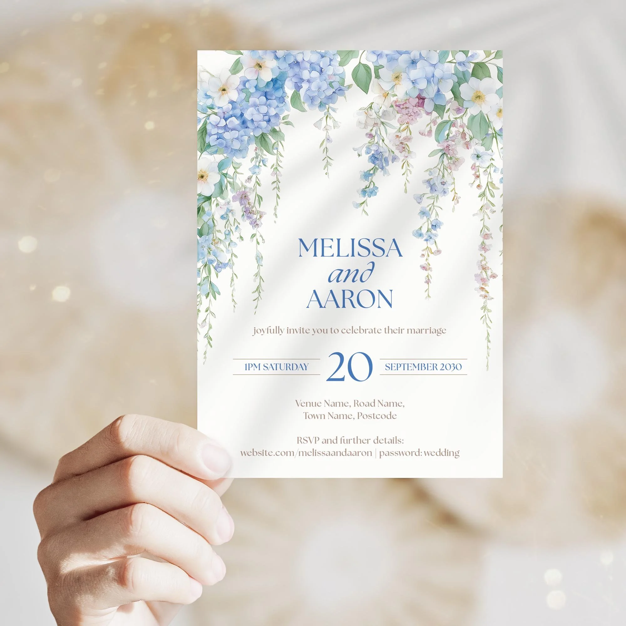 Person holding the Serenity Wedding Invitation with wisteria-style blue flowers and sophisticated design.