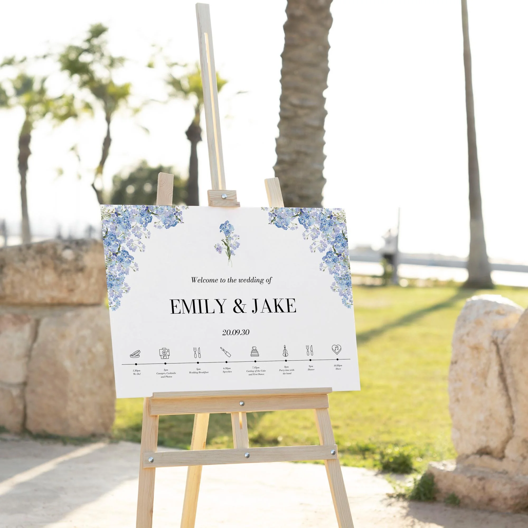Forget Me Not Custom Timeline of the Day wedding welcome sign displayed outdoors at a wedding venue on an easel