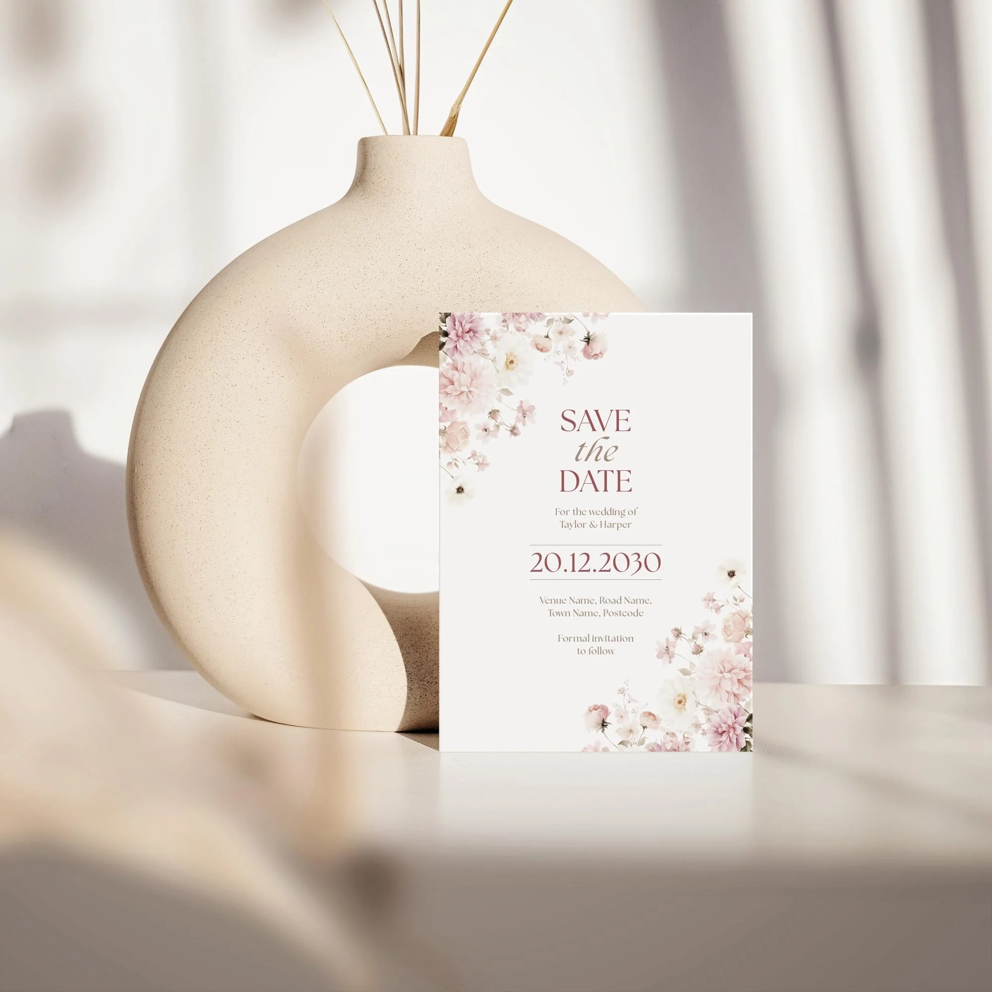 Elevated upright view of the Petal Save the Date featuring modern pink typography.