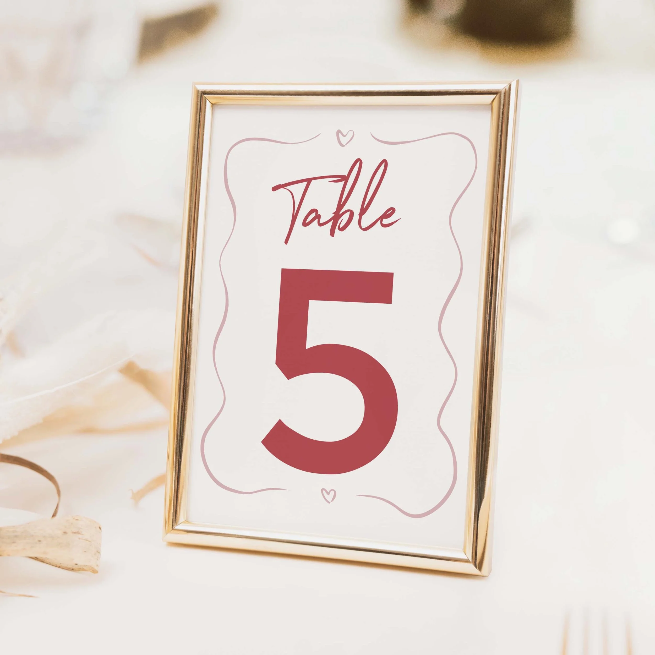 Whimsical Pink wedding table number with burgundy pink wavy scallop border, bold numeral and modern typography on luxury off-white card