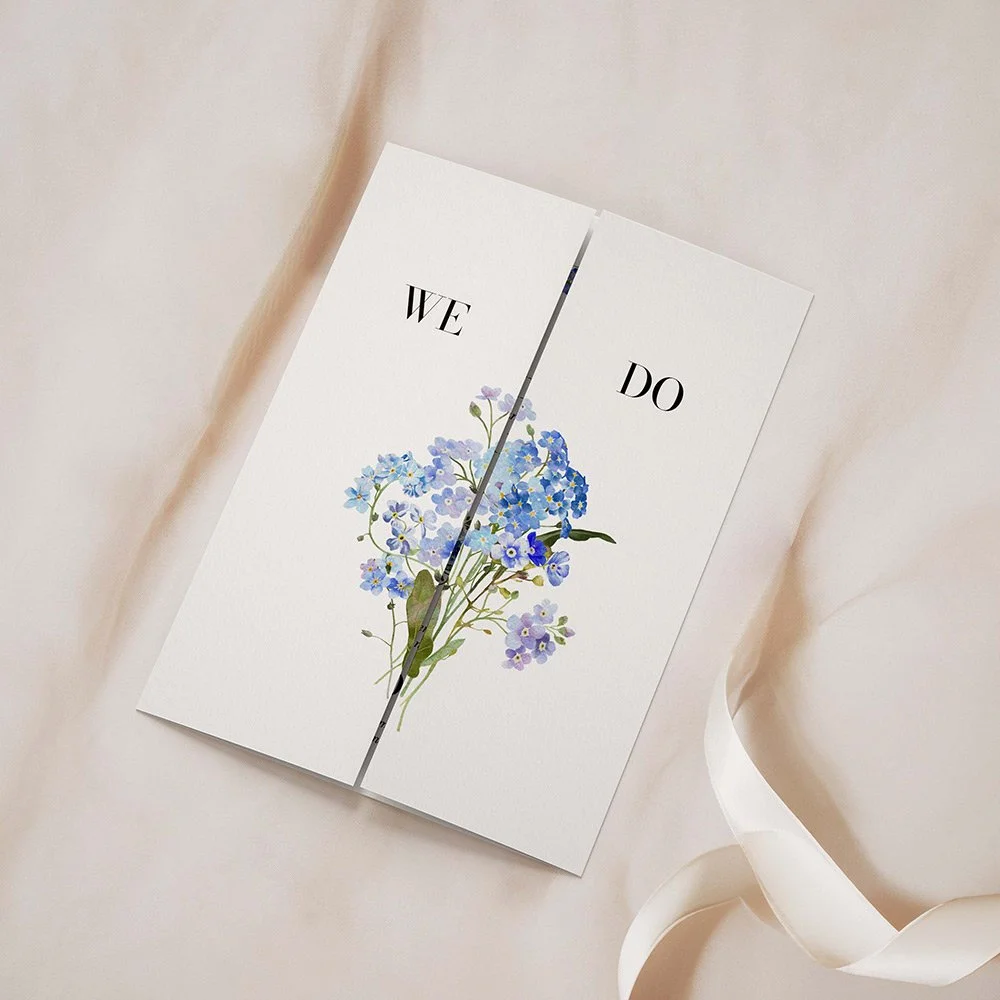 Forget Me Not Collection Frame gatefold invitation closed, featuring a soft blue floral frame surrounding the wedding text.