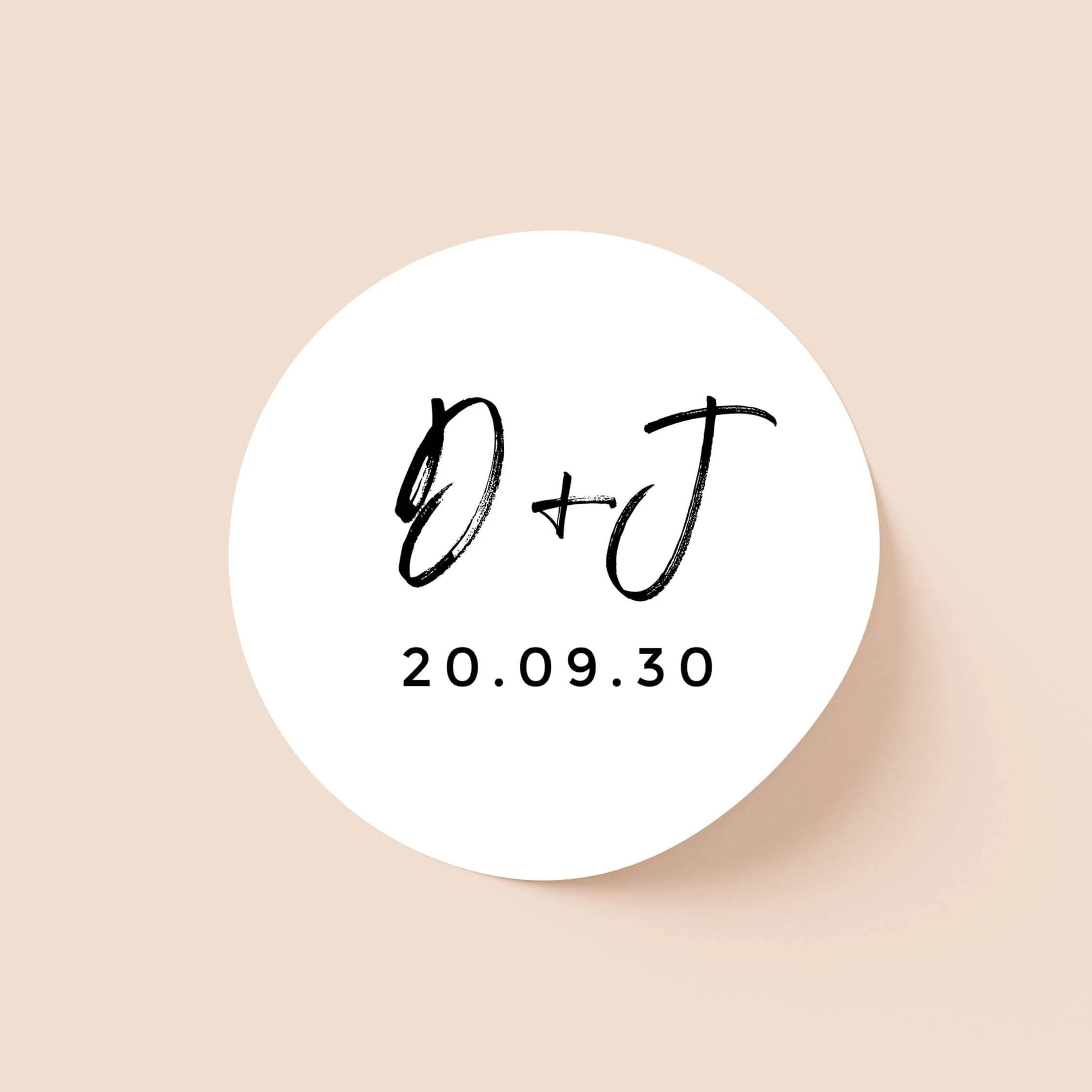 Signature personalised wedding sticker with bold black script initials and wedding date on round white sticker