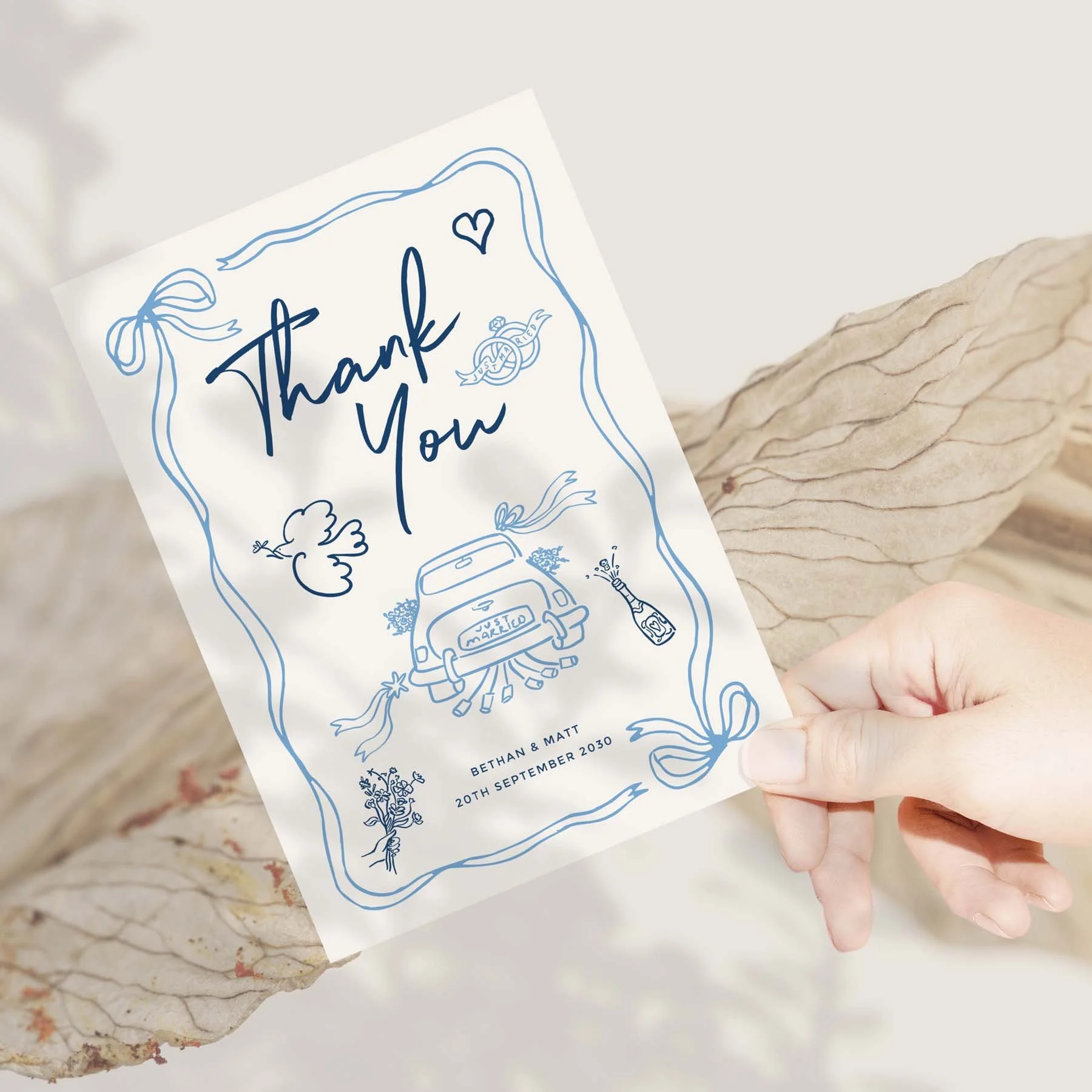 Hand holding a Blue Doodle Style wedding thank you card