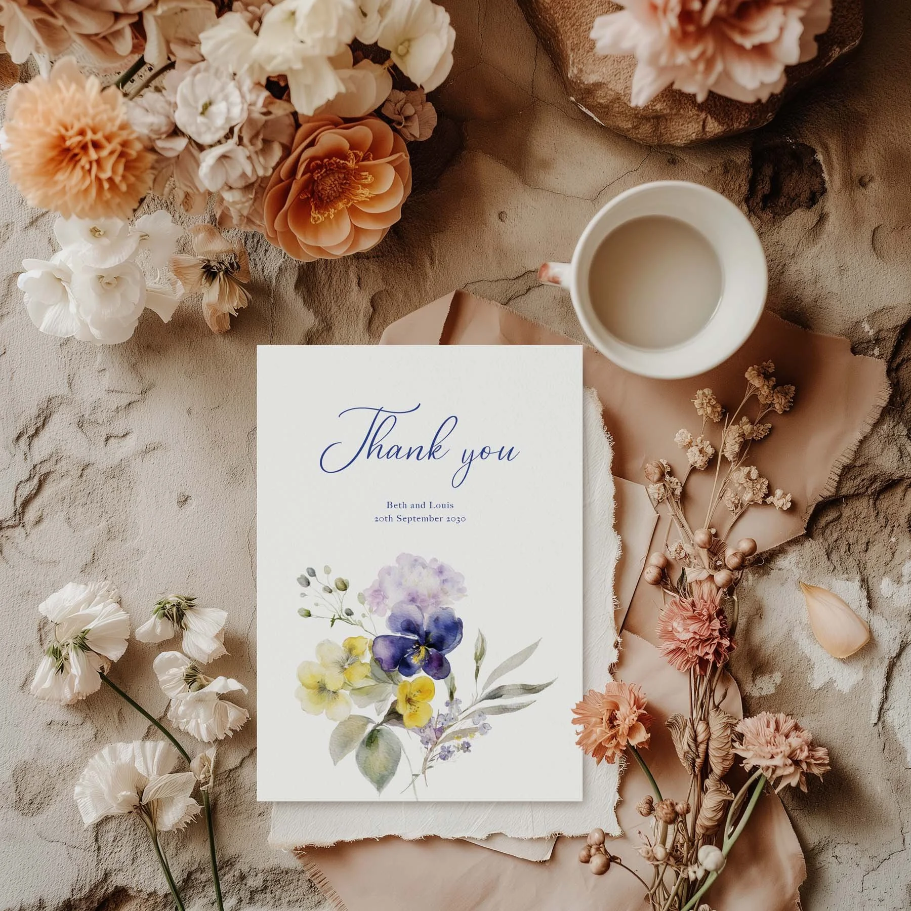 Violet wedding thank you card styled with flowers and stationery details