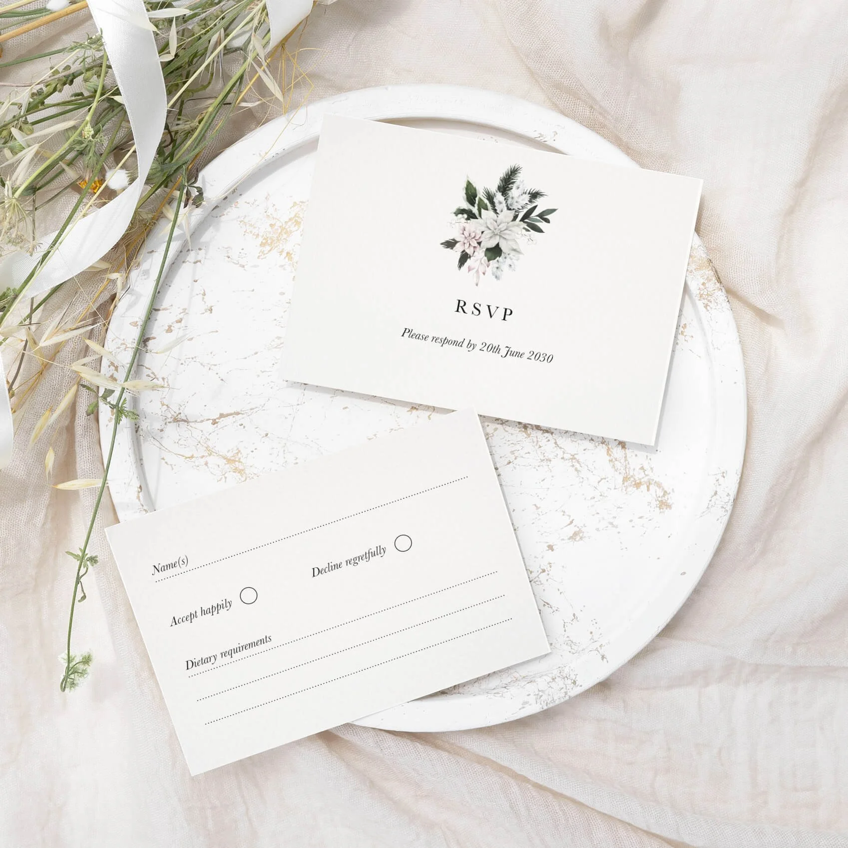 Winter Frost wedding RSVP card with white poinsettia and pine foliage illustration on luxury off-white card