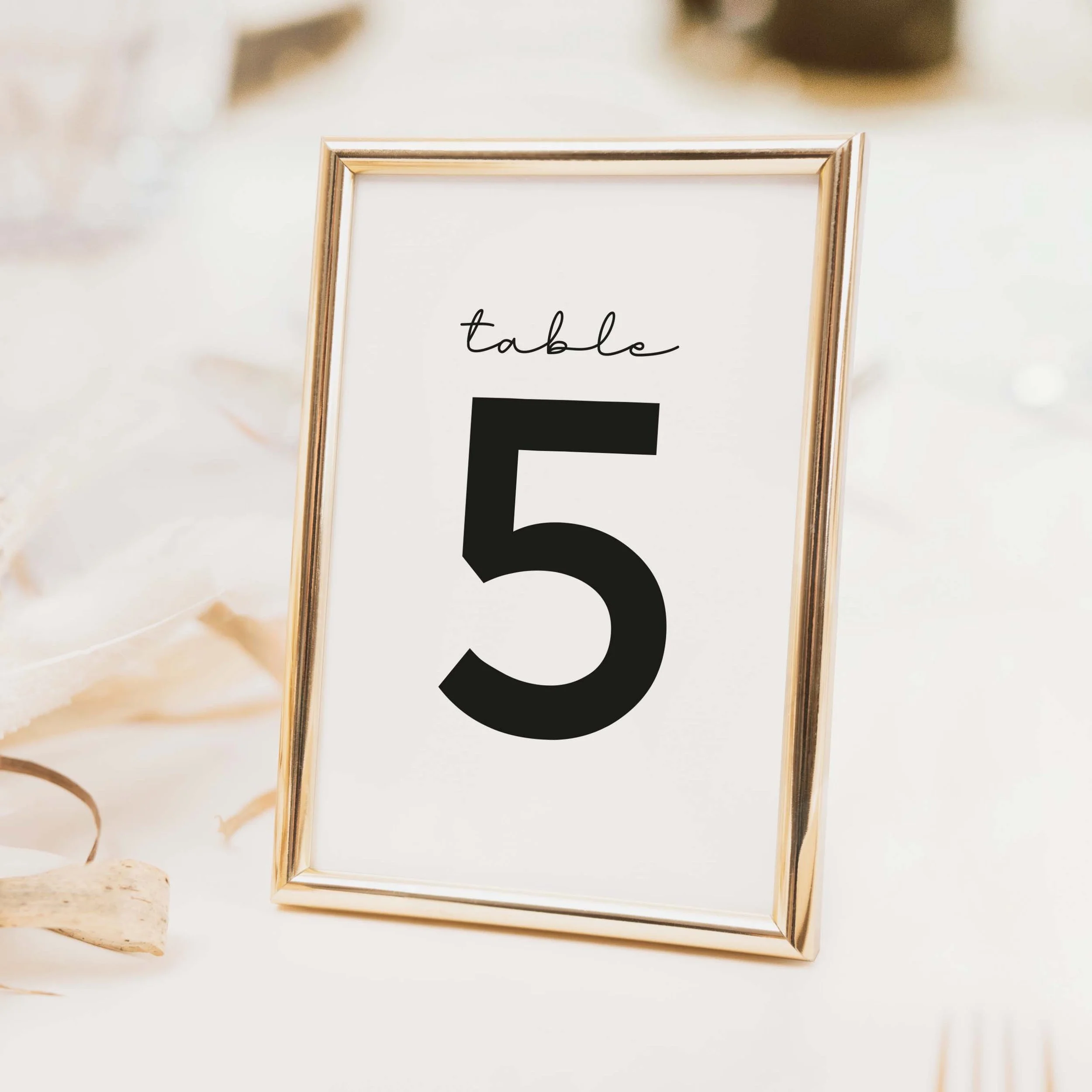 Classic wedding table number with bold black serif numeral and refined border on a crisp white background printed on luxury off-white textured card